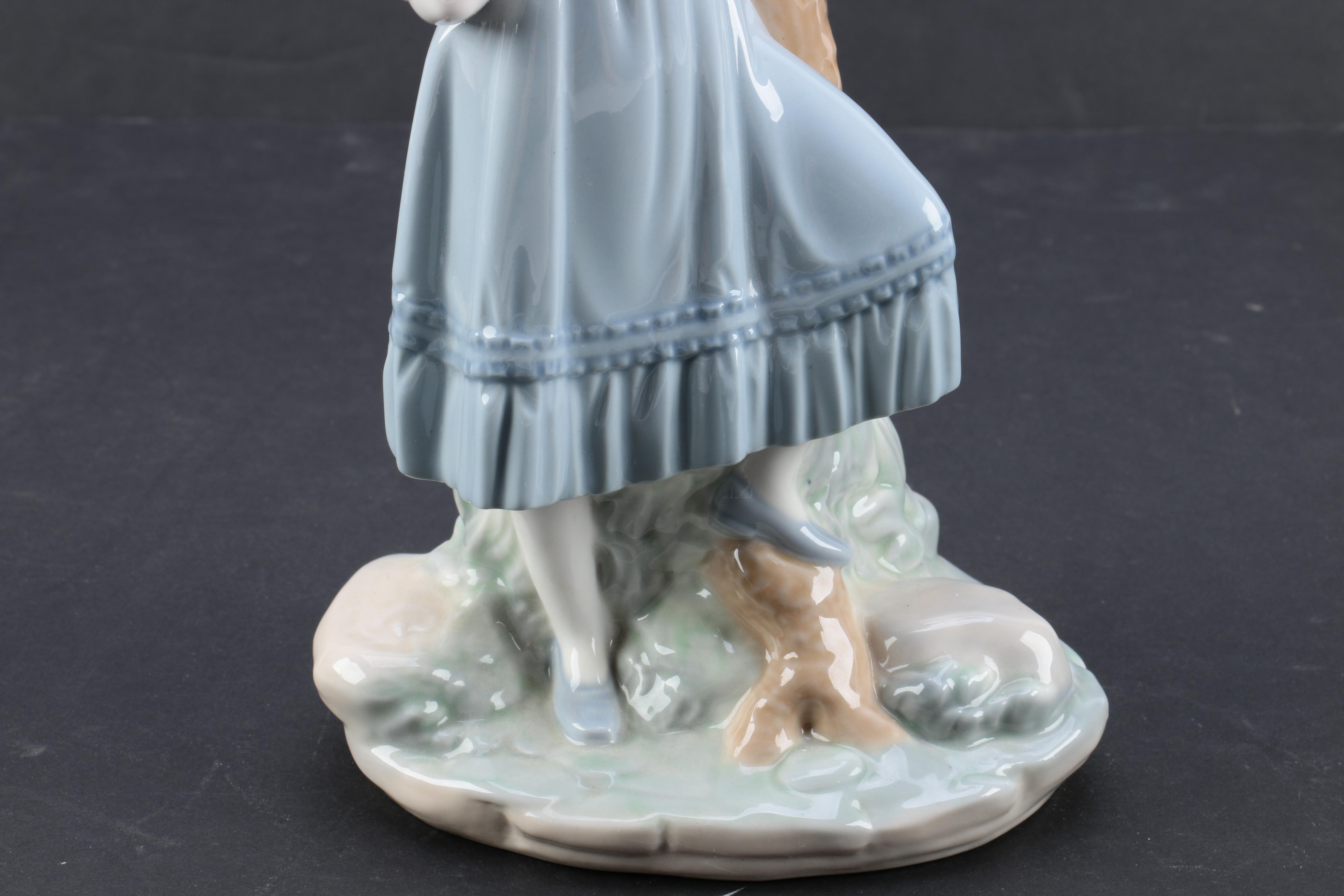 NAO by Lladró "Girl Pointing at Bird Nest" Porcelain Figurine