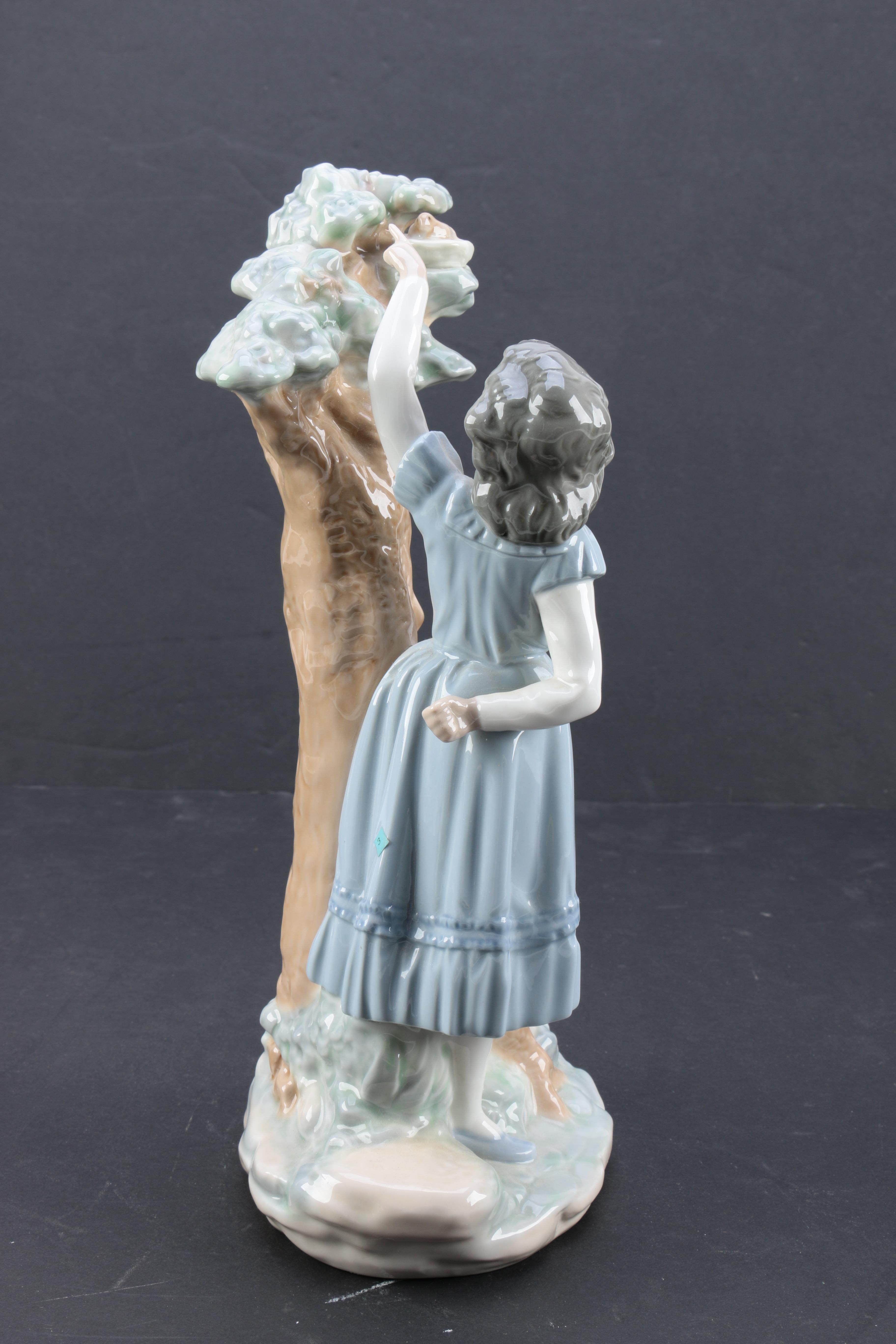 NAO by Lladró "Girl Pointing at Bird Nest" Porcelain Figurine