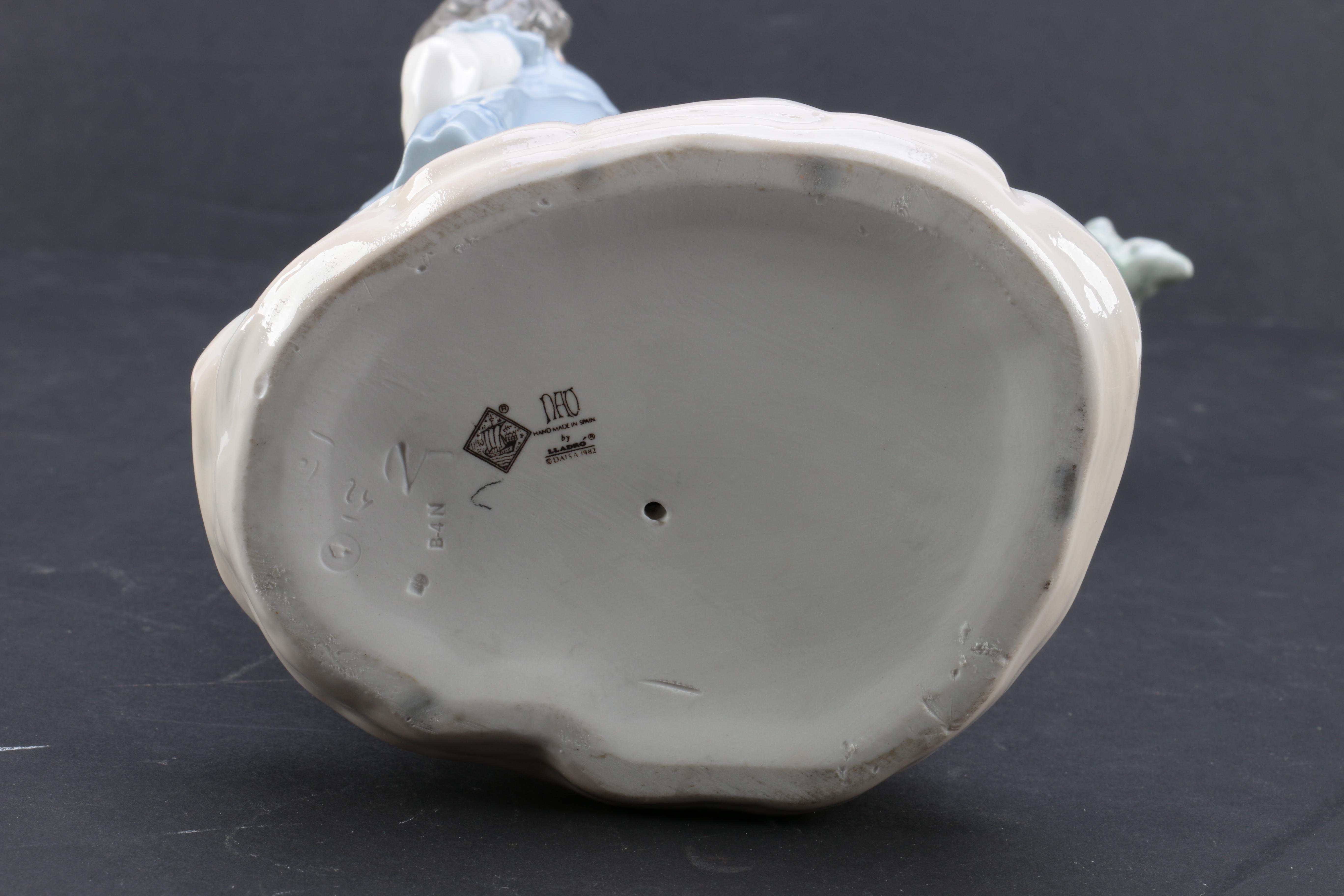 NAO by Lladró "Girl Pointing at Bird Nest" Porcelain Figurine