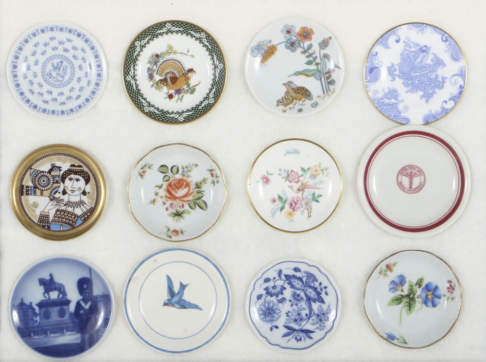 Twelve Porcelain Butter Pats In Glass Top Display Case