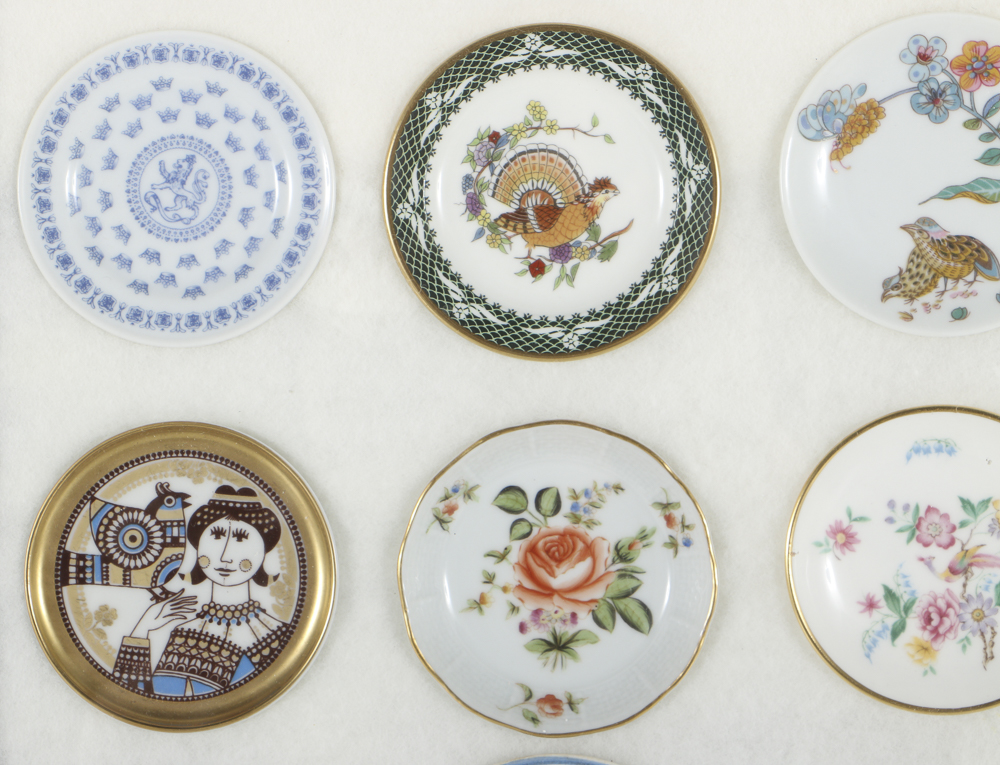 Twelve Porcelain Butter Pats In Glass Top Display Case