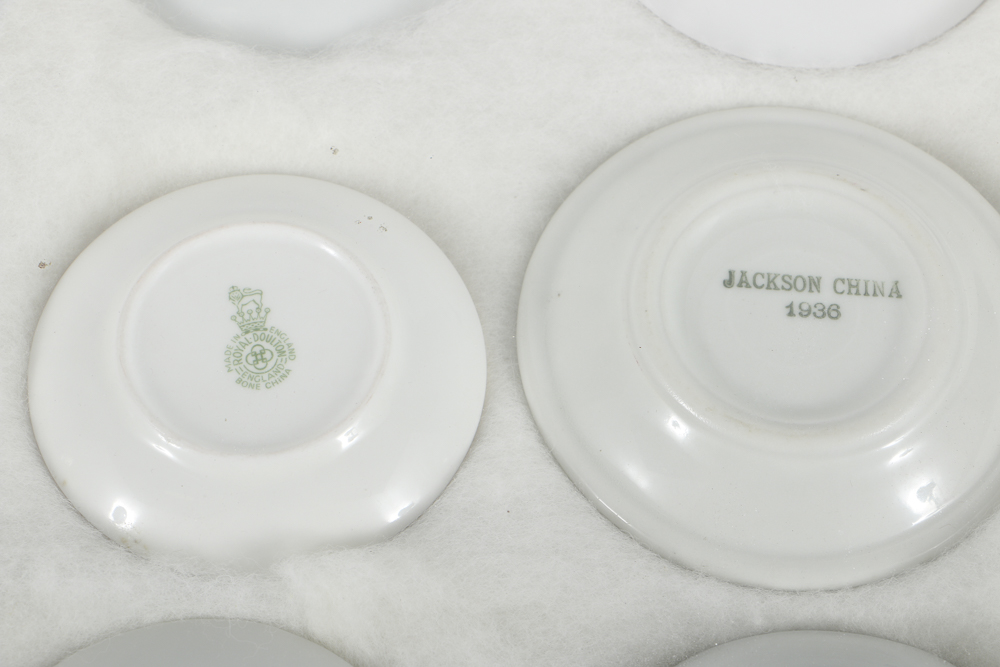 Twelve Porcelain Butter Pats In Glass Top Display Case