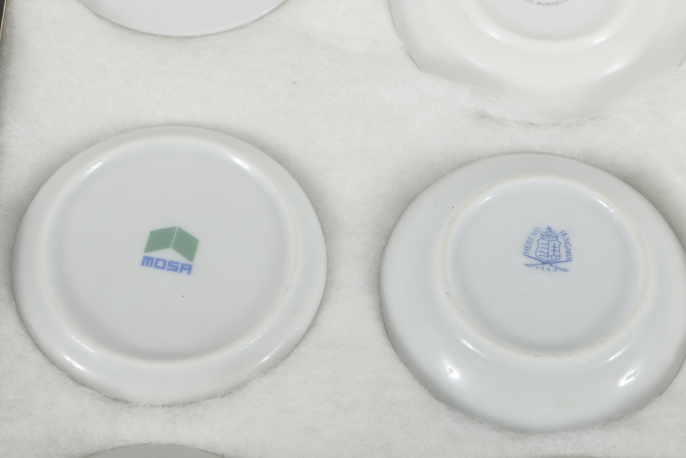 Twelve Porcelain Butter Pats In Glass Top Display Case