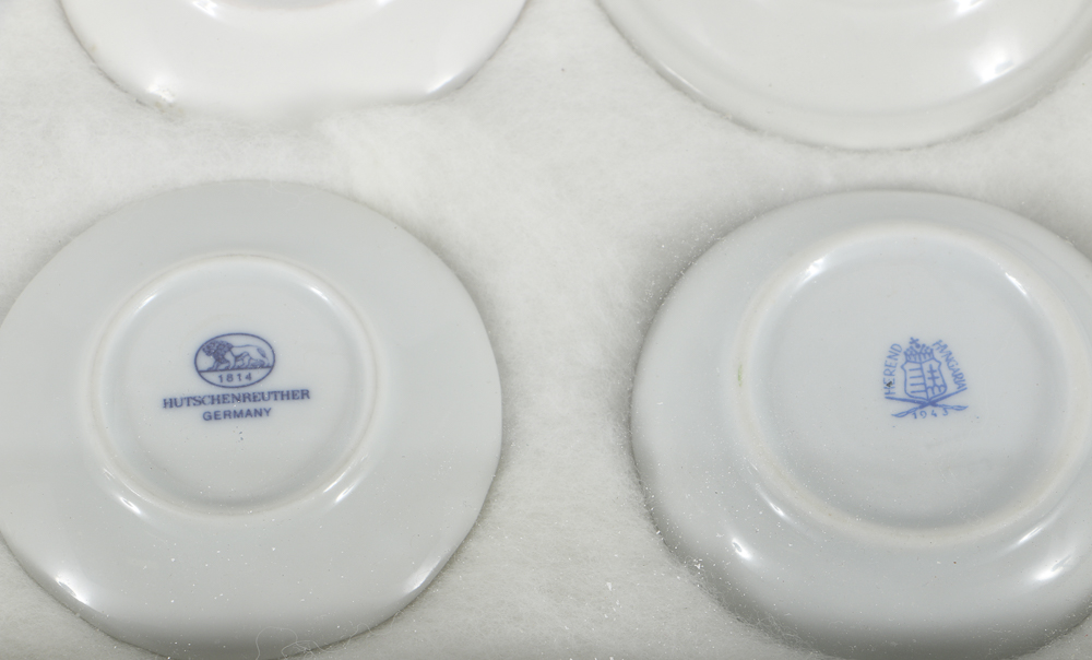 Twelve Porcelain Butter Pats In Glass Top Display Case