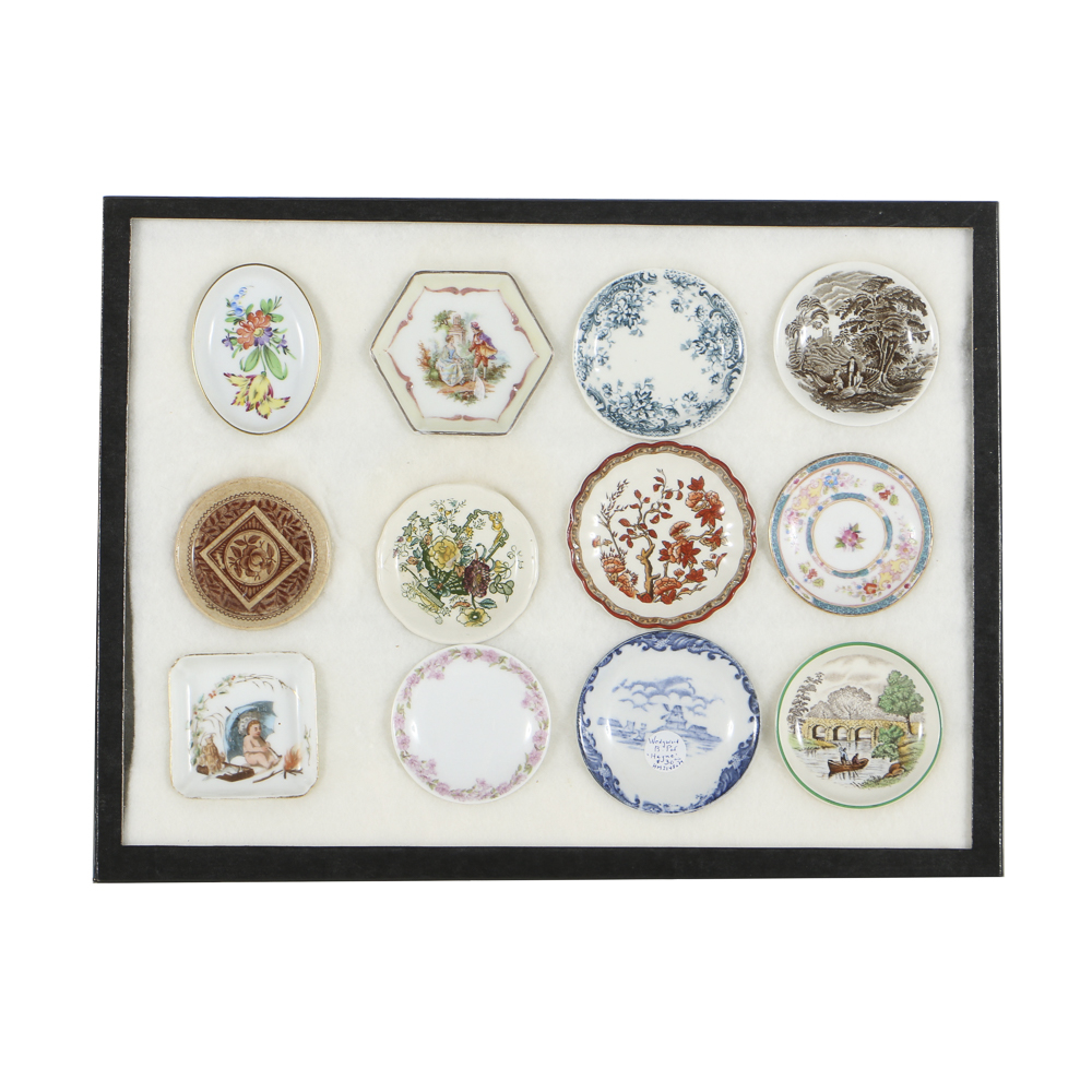Twelve Porcelain Butter Pats In Glass Top Display Case
