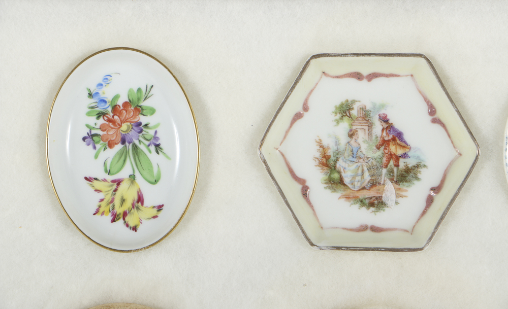 Twelve Porcelain Butter Pats In Glass Top Display Case