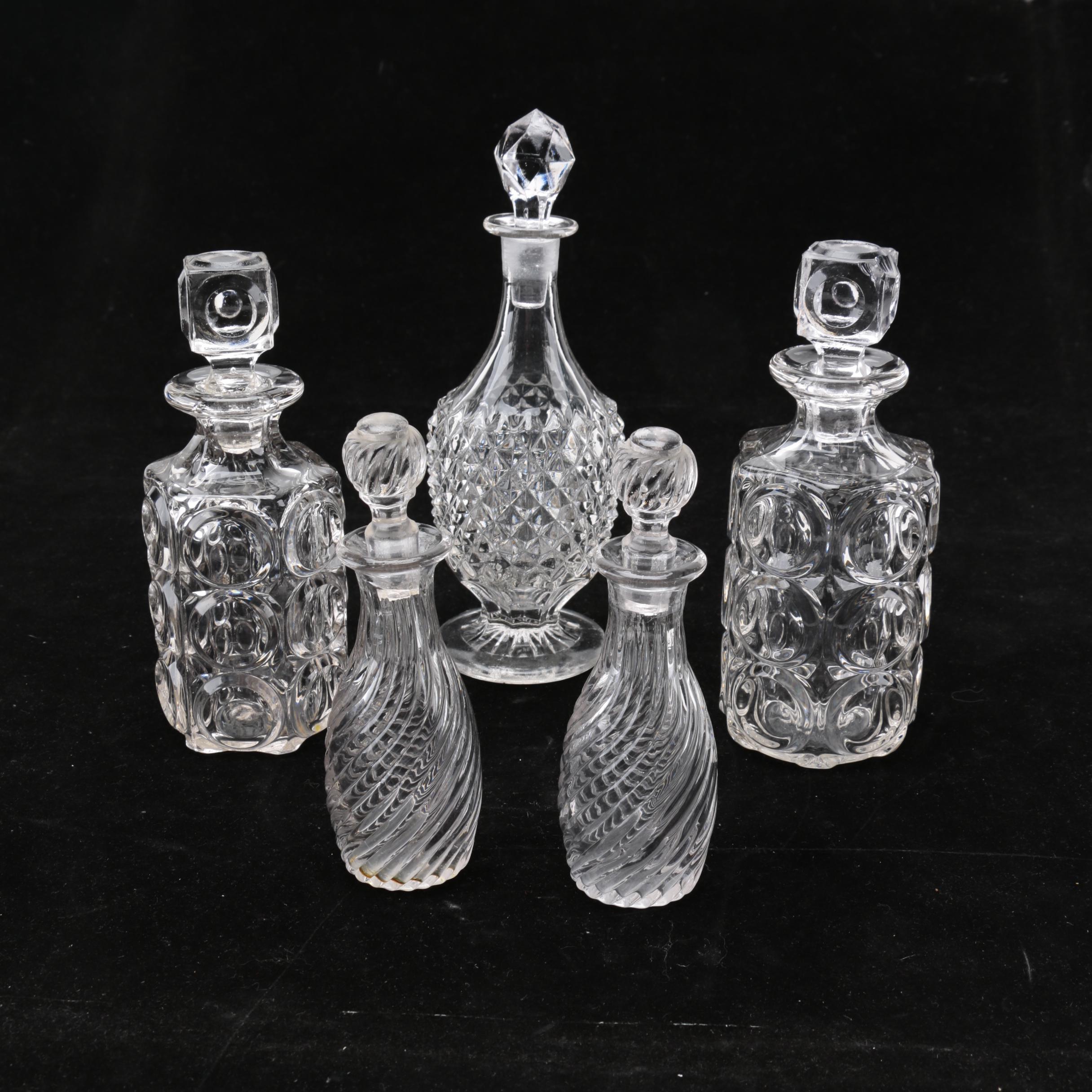 Group of Cut and Molded Glass Decanters with Decorative Stoppers