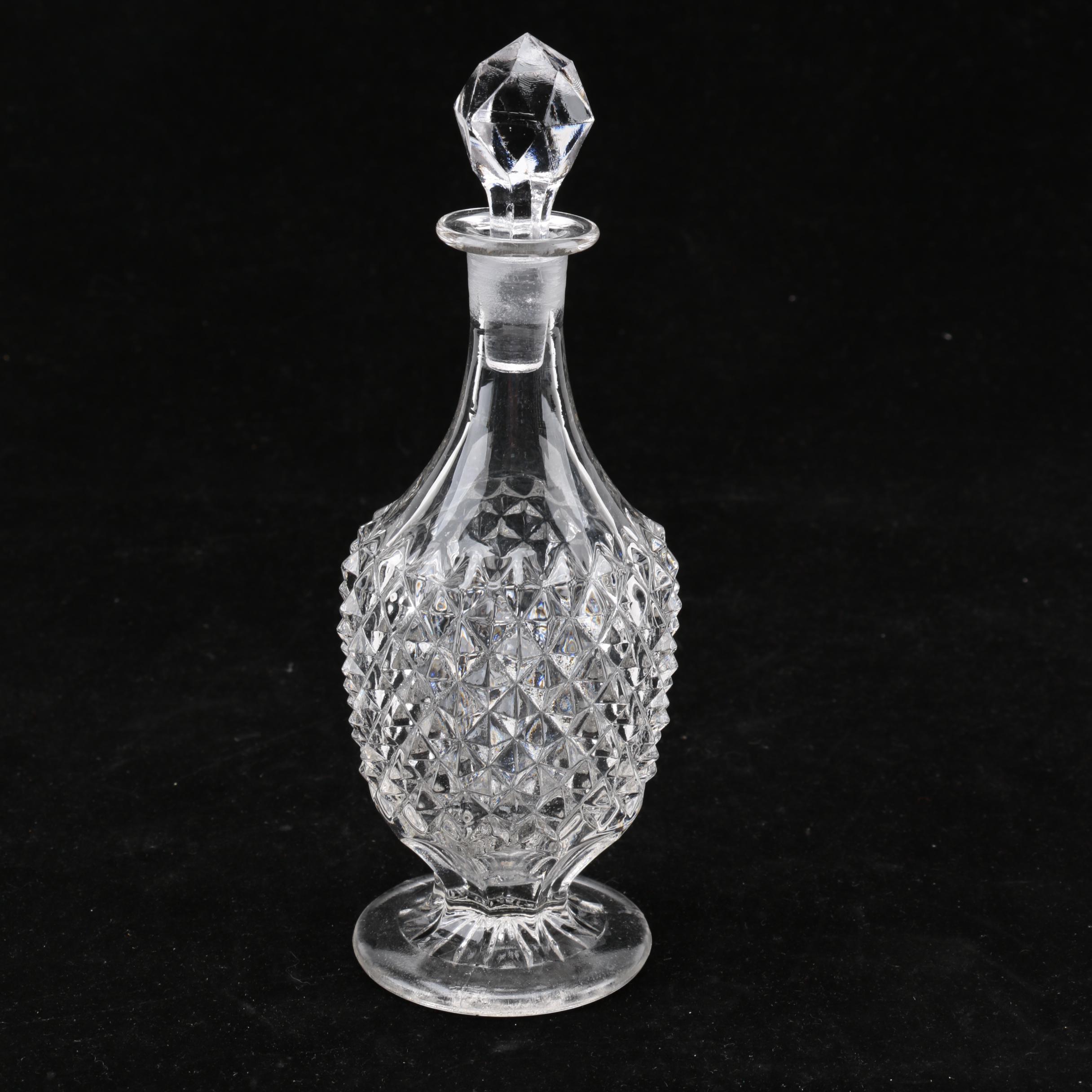 Group of Cut and Molded Glass Decanters with Decorative Stoppers