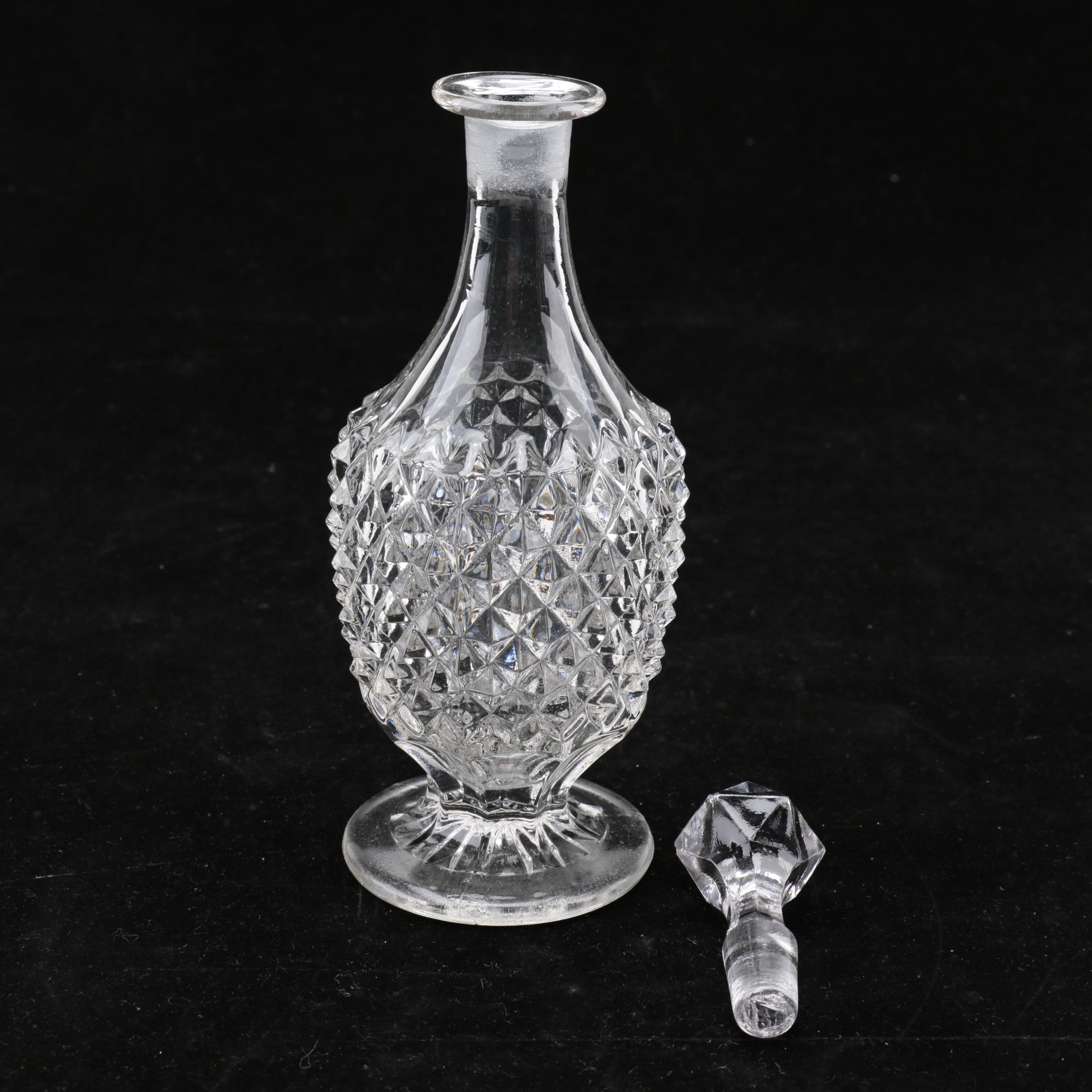 Group of Cut and Molded Glass Decanters with Decorative Stoppers