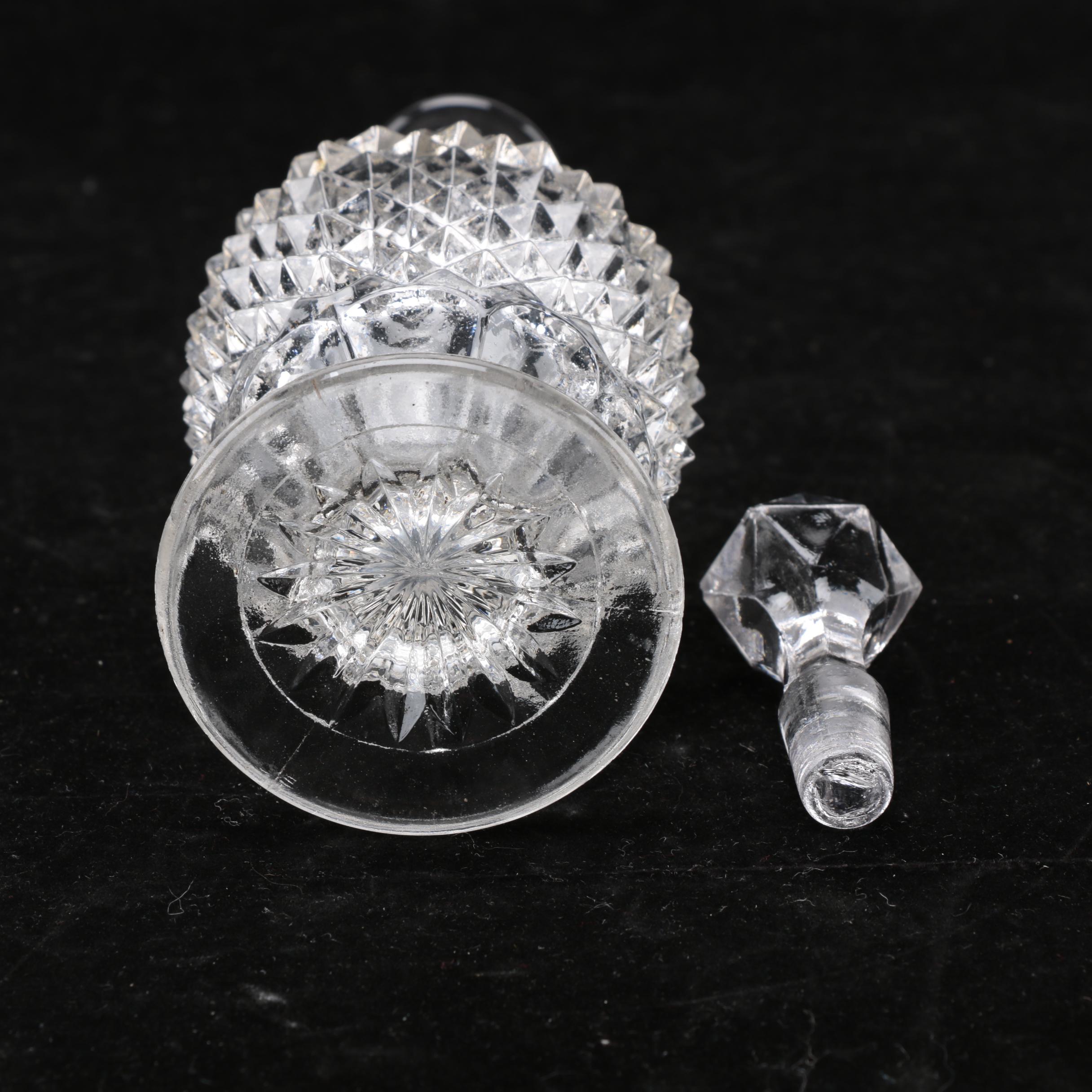 Group of Cut and Molded Glass Decanters with Decorative Stoppers