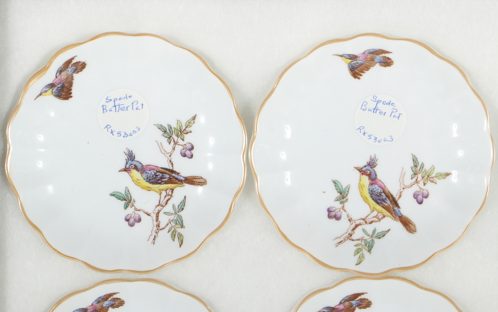 Twelve Porcelain Butter Pats In Glass Top Display Case