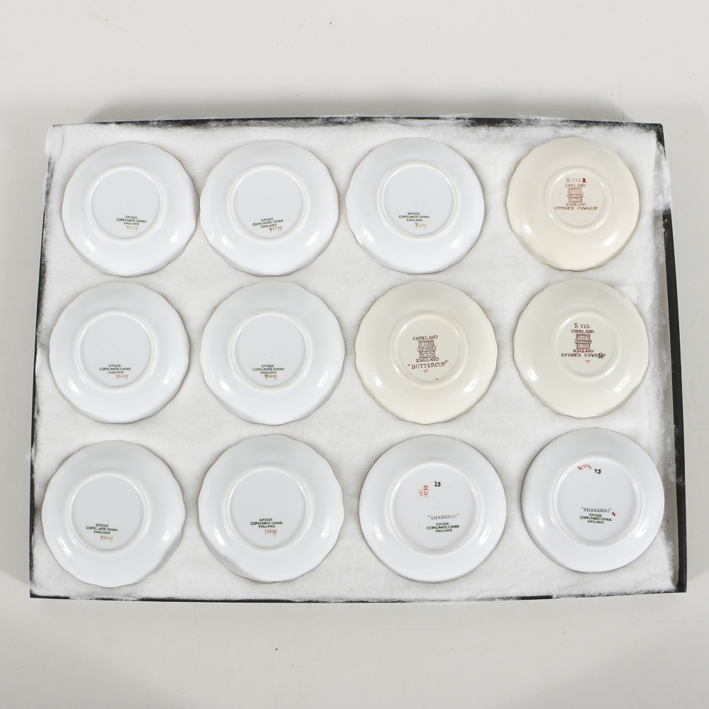 Twelve Porcelain Butter Pats In Glass Top Display Case