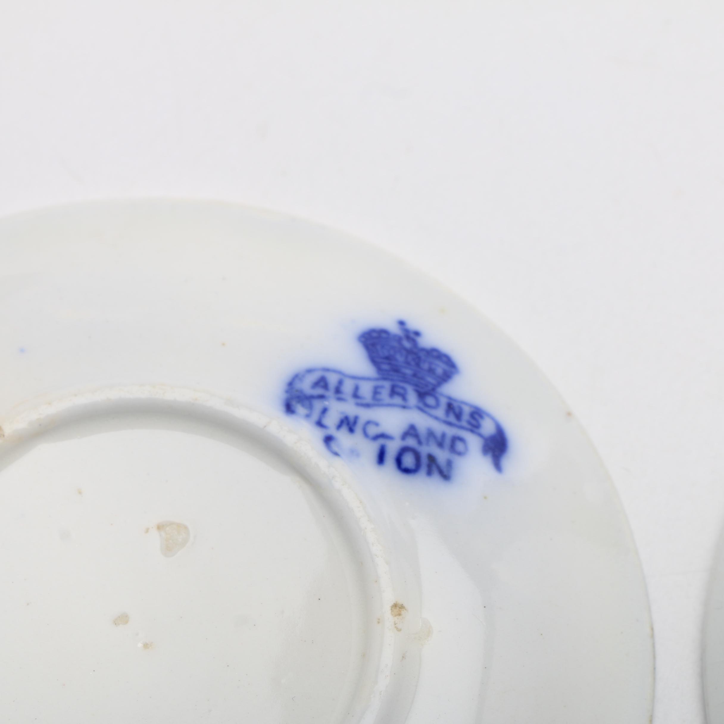 Twelve Porcelain Butter Pats In Glass Top Display Case