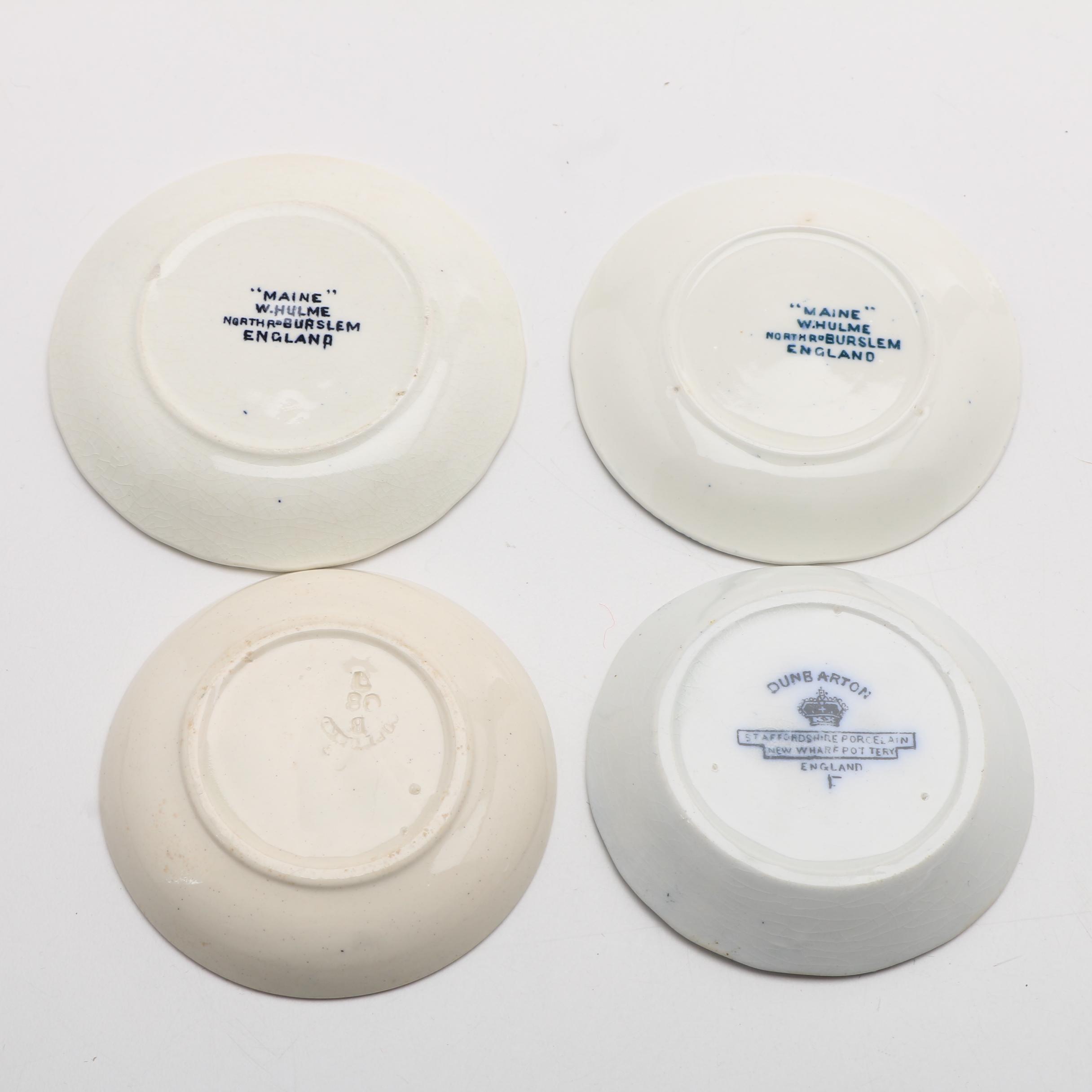 Twelve Porcelain Butter Pats In Glass Top Display Case