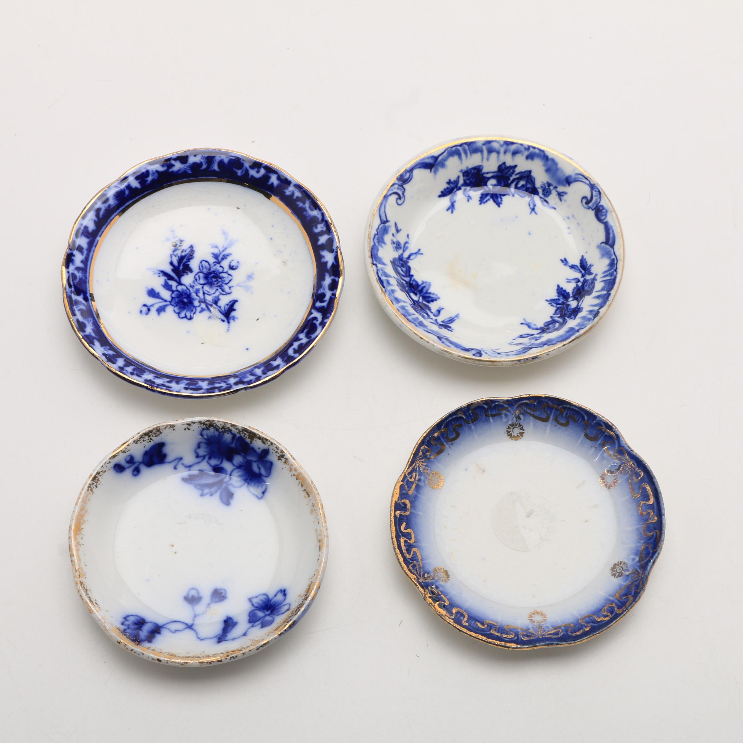 Twelve Porcelain Butter Pats In Glass Top Display Case