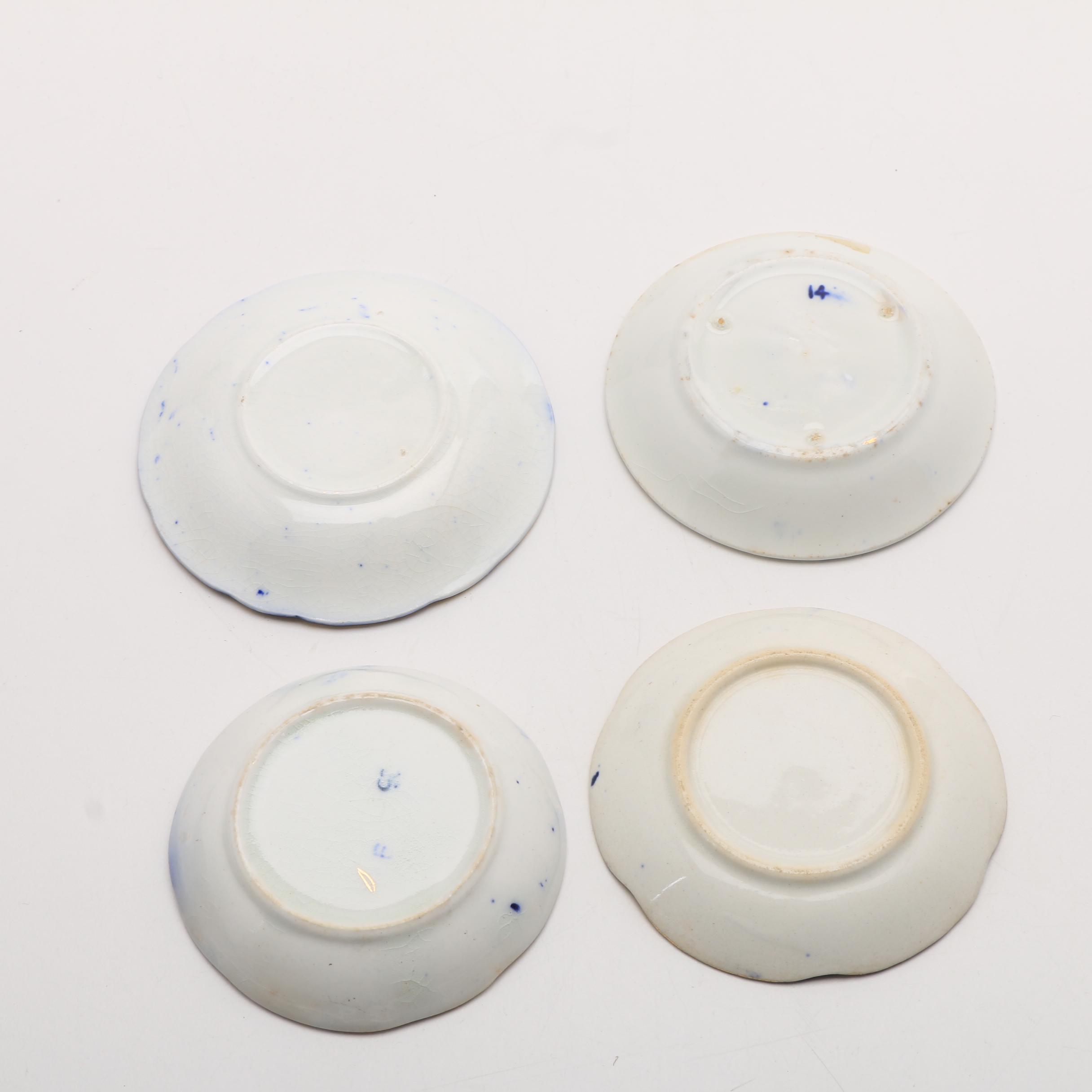 Twelve Porcelain Butter Pats In Glass Top Display Case