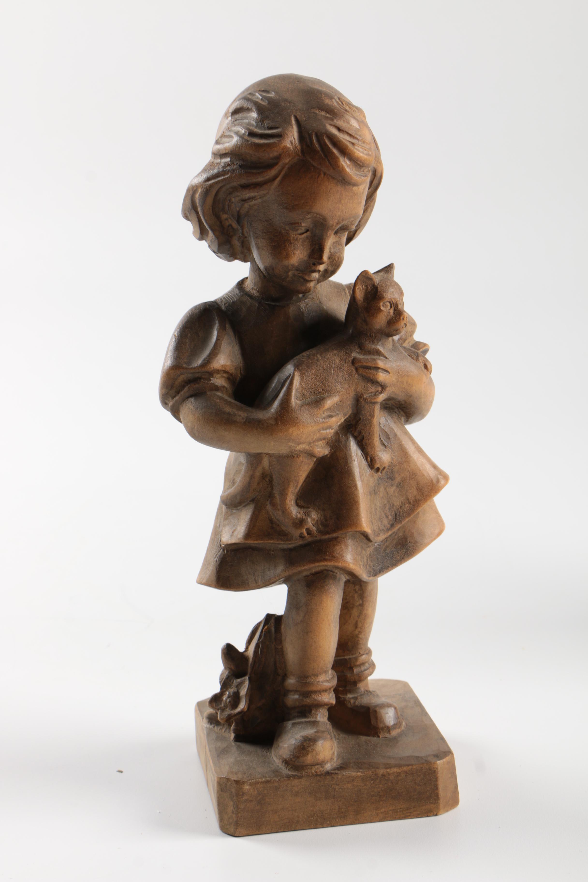 Carved Wood Figurines Featuring Children