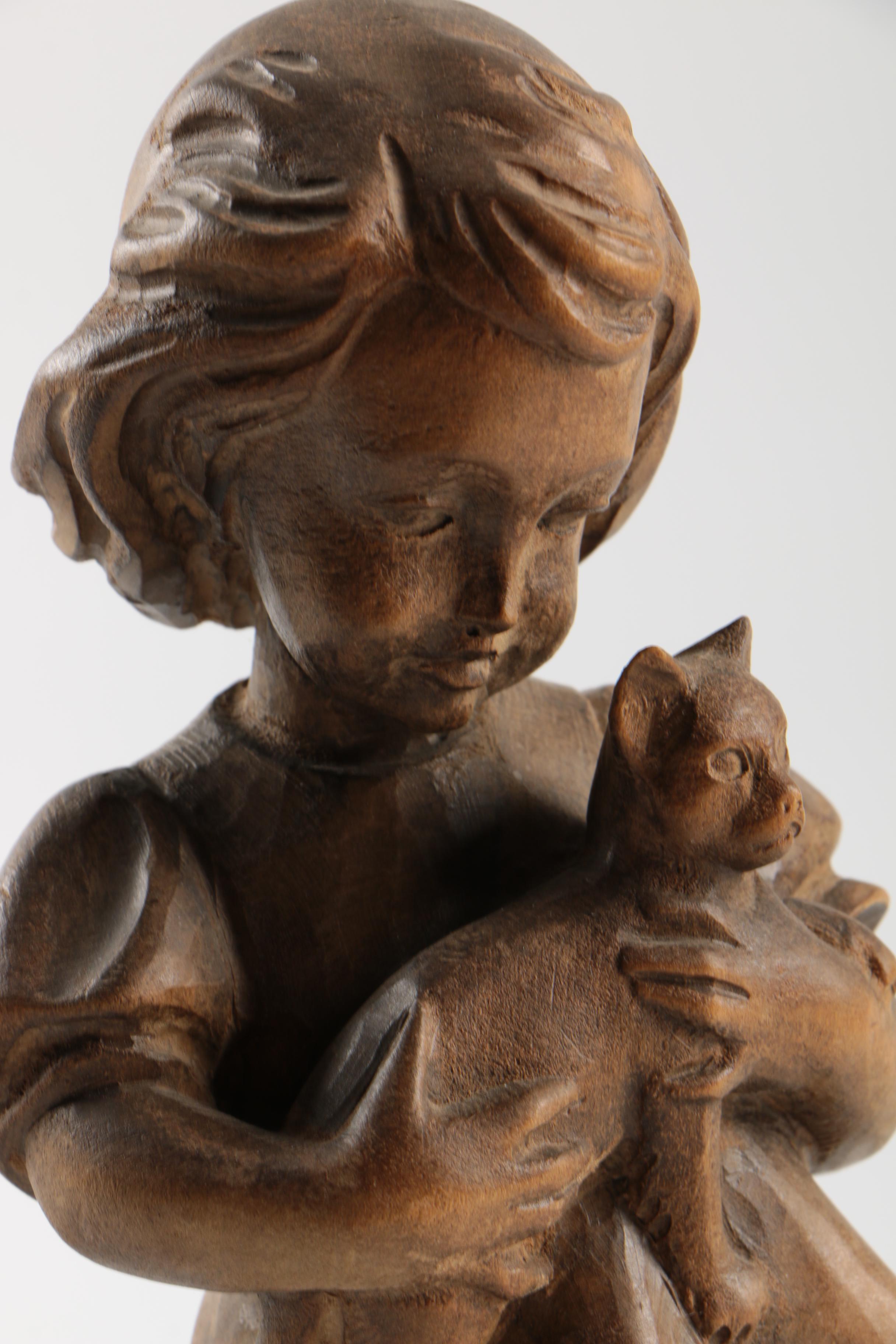 Carved Wood Figurines Featuring Children