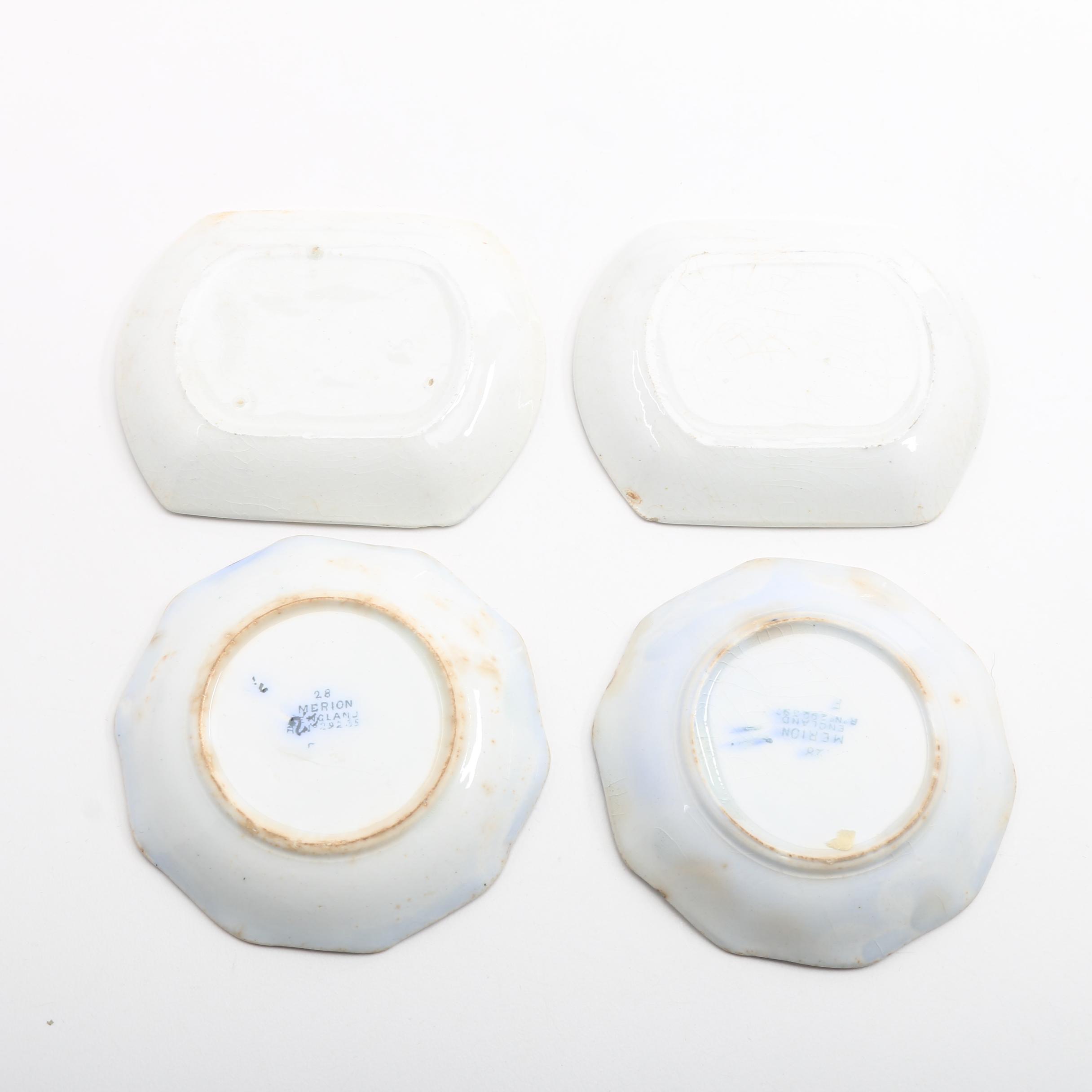 Twelve Porcelain Butter Pats In Glass Top Display Case