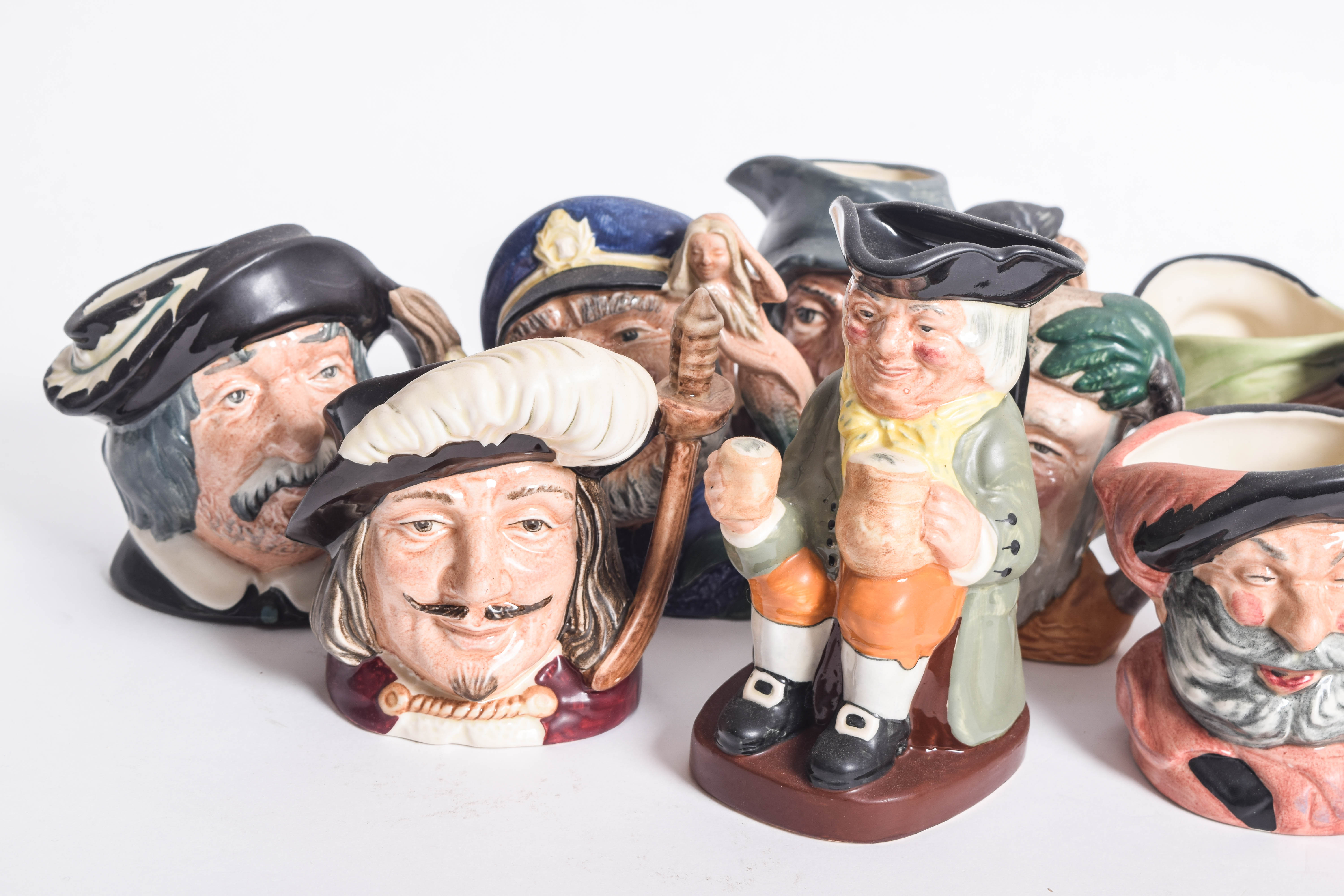 Generous Assortment of  of Royal Doulton Toby Jugs and Character Mugs