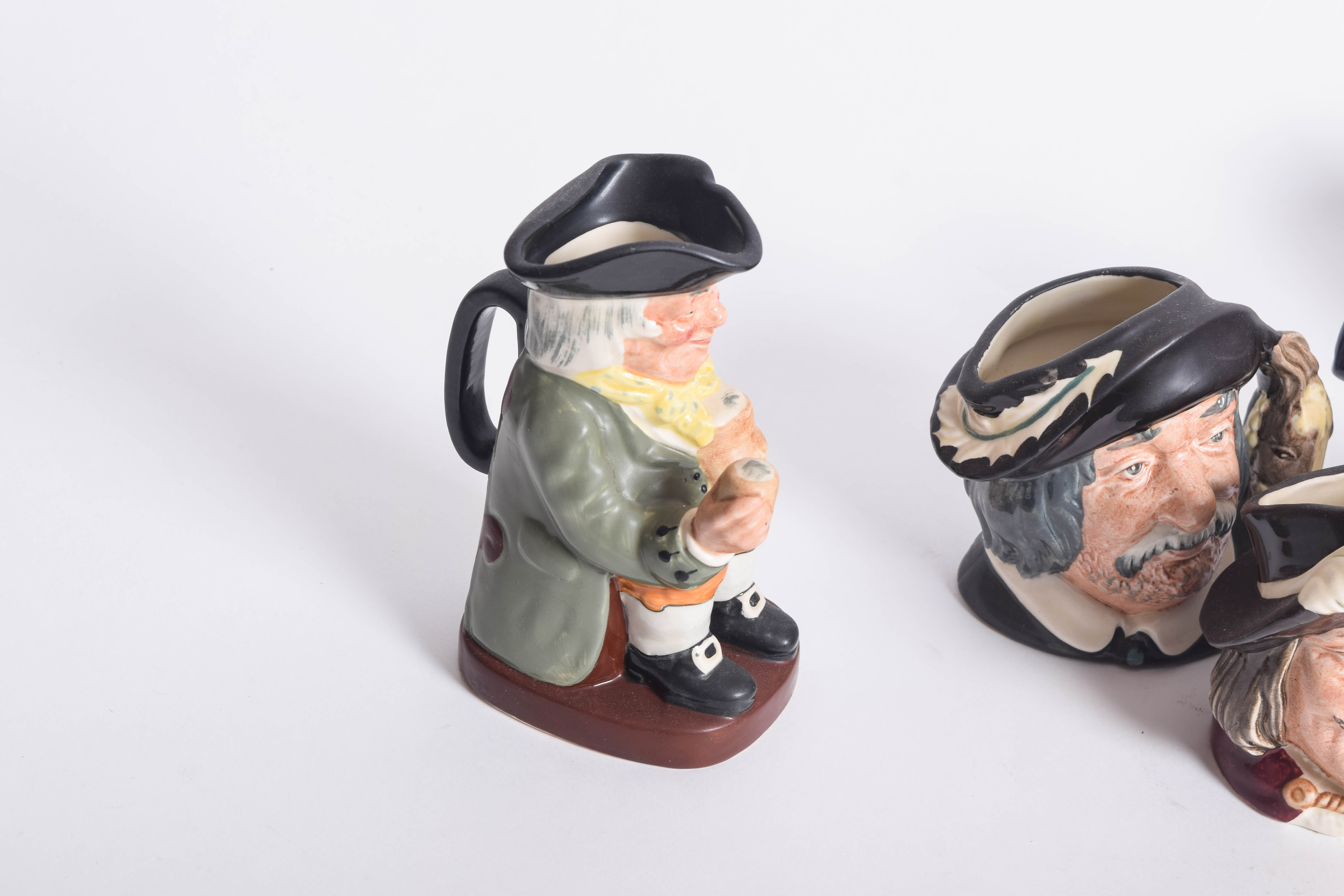 Generous Assortment of  of Royal Doulton Toby Jugs and Character Mugs