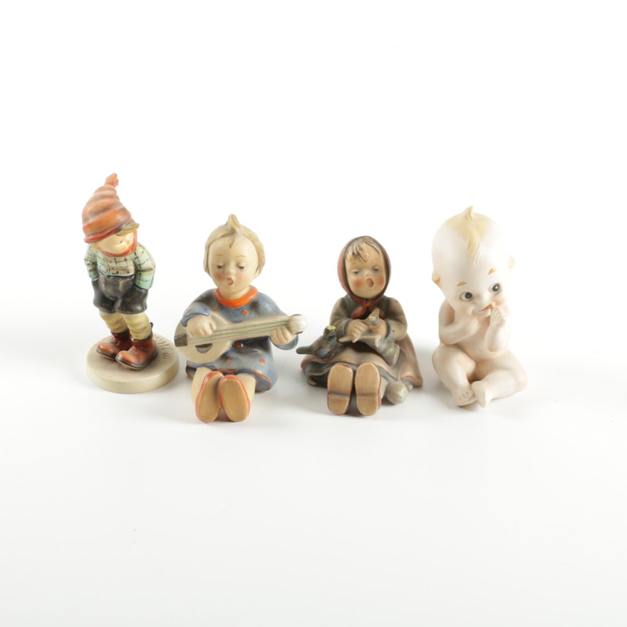 Group of Hummel Figurines and a Kewpie Doll