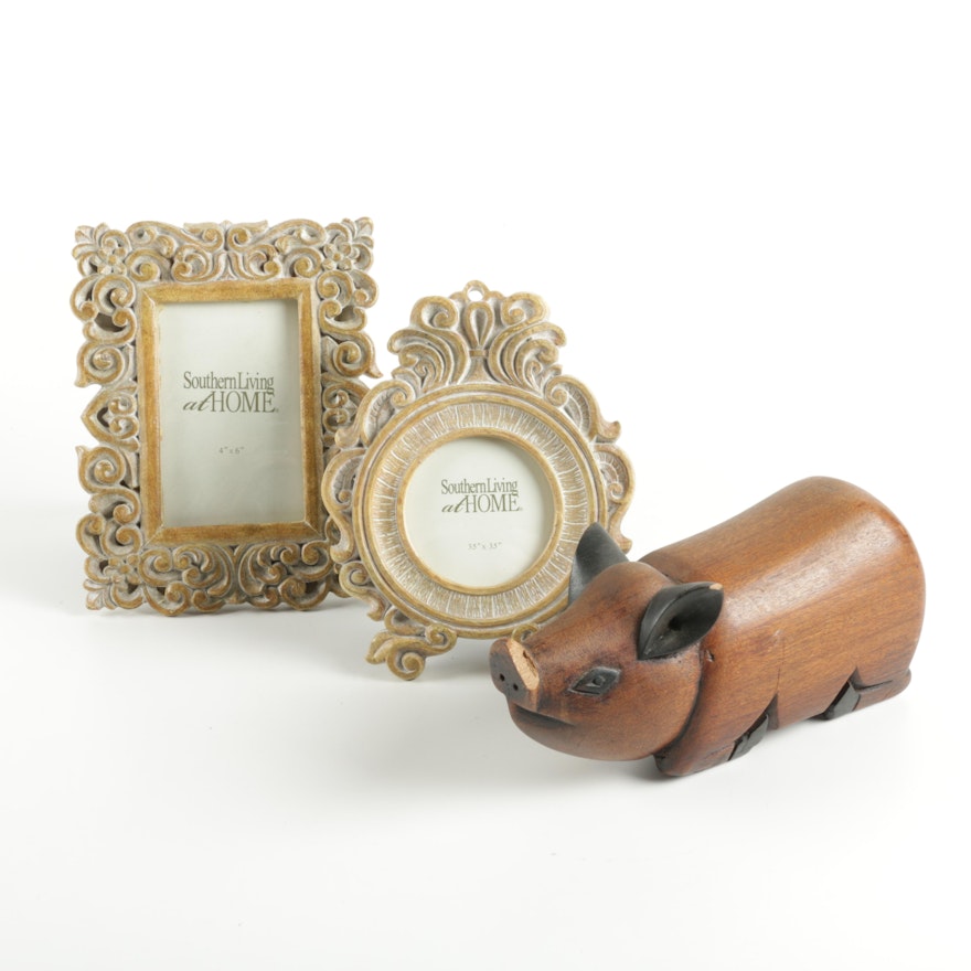 Small Decorative Picture Frames and a Wooden Figurine of a Pig