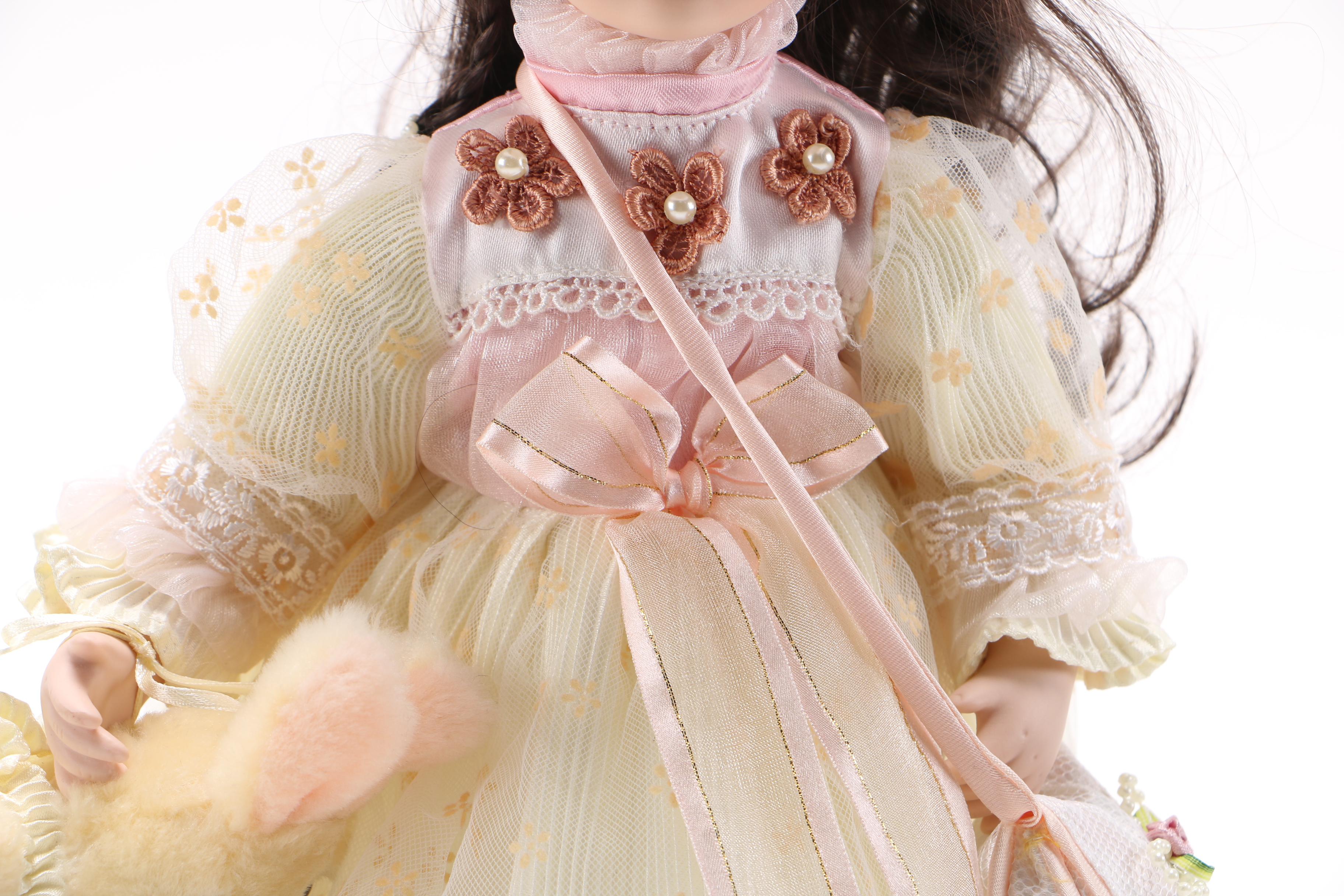 Porcelain Doll with Stuffed Rabbit