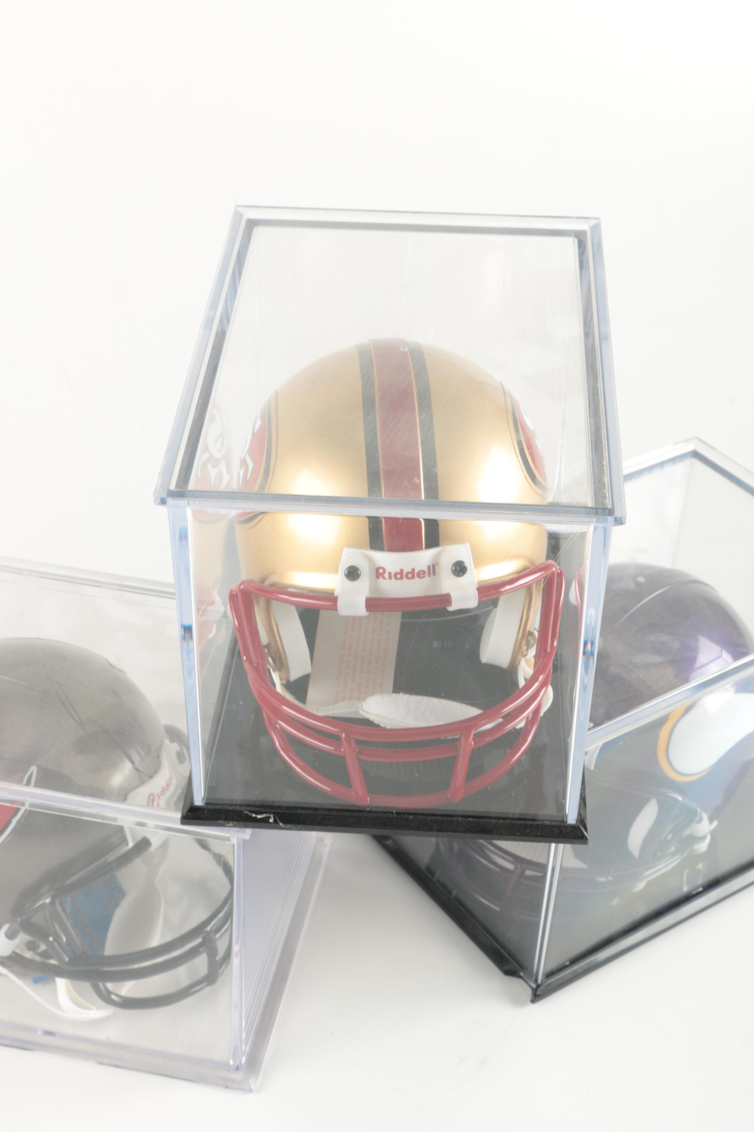 Four Miniature Football Helmets in Cases