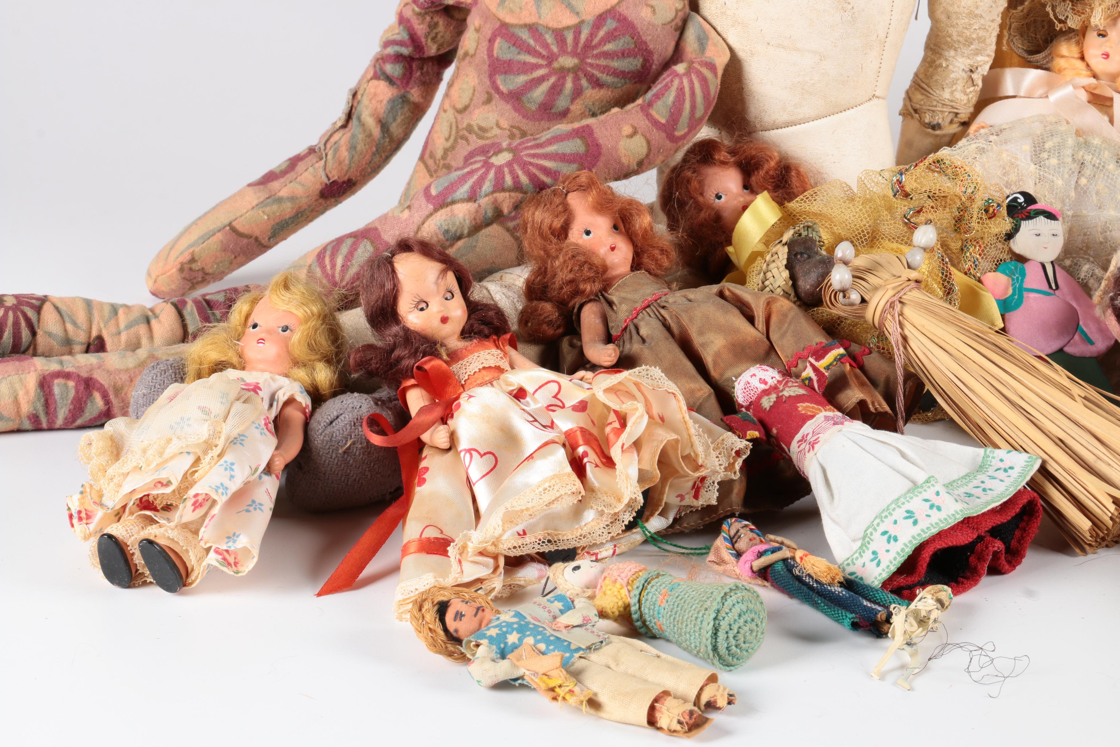 Variety of Dolls and Wooden Cabinet