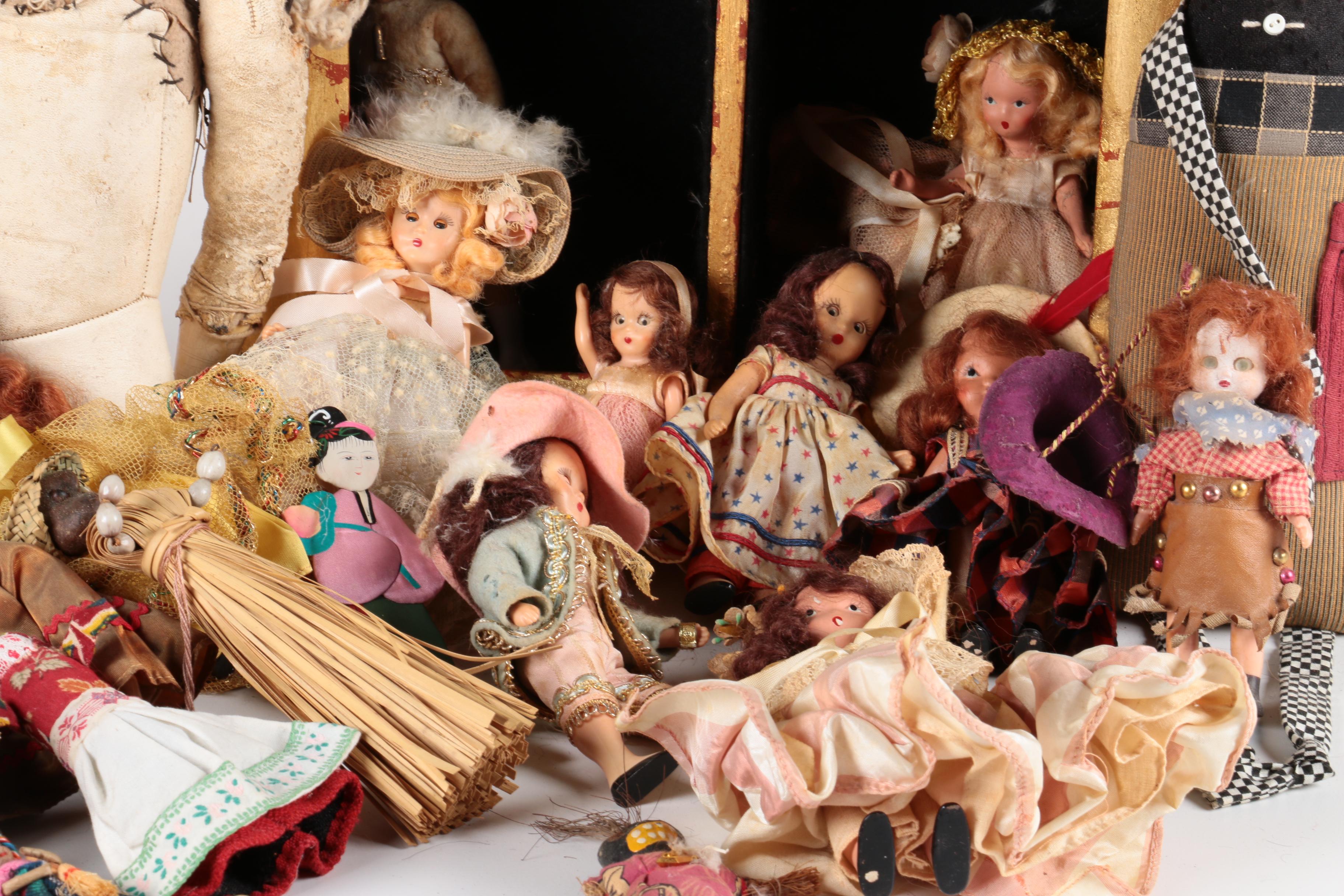 Variety of Dolls and Wooden Cabinet