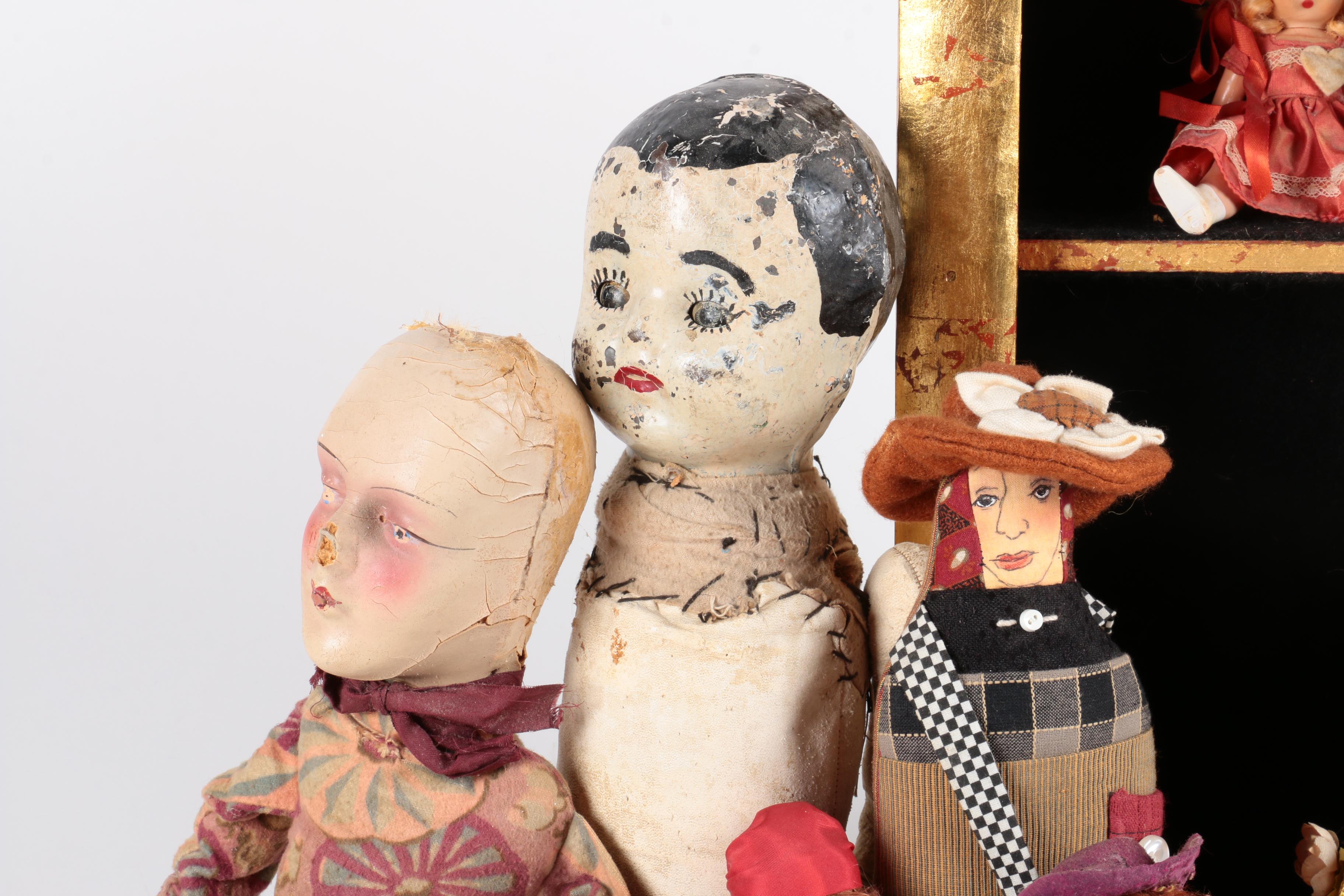 Variety of Dolls and Wooden Cabinet