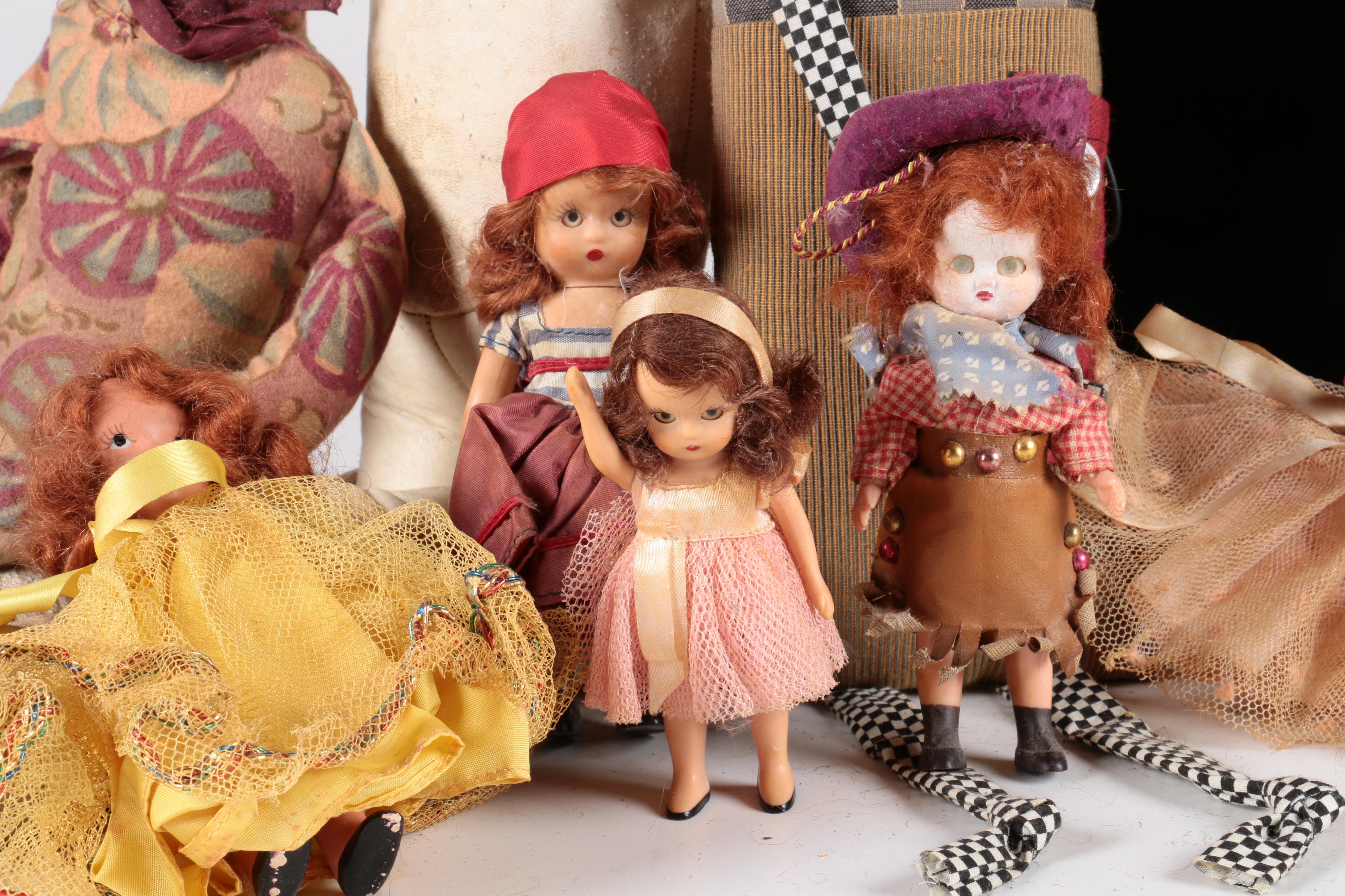 Variety of Dolls and Wooden Cabinet