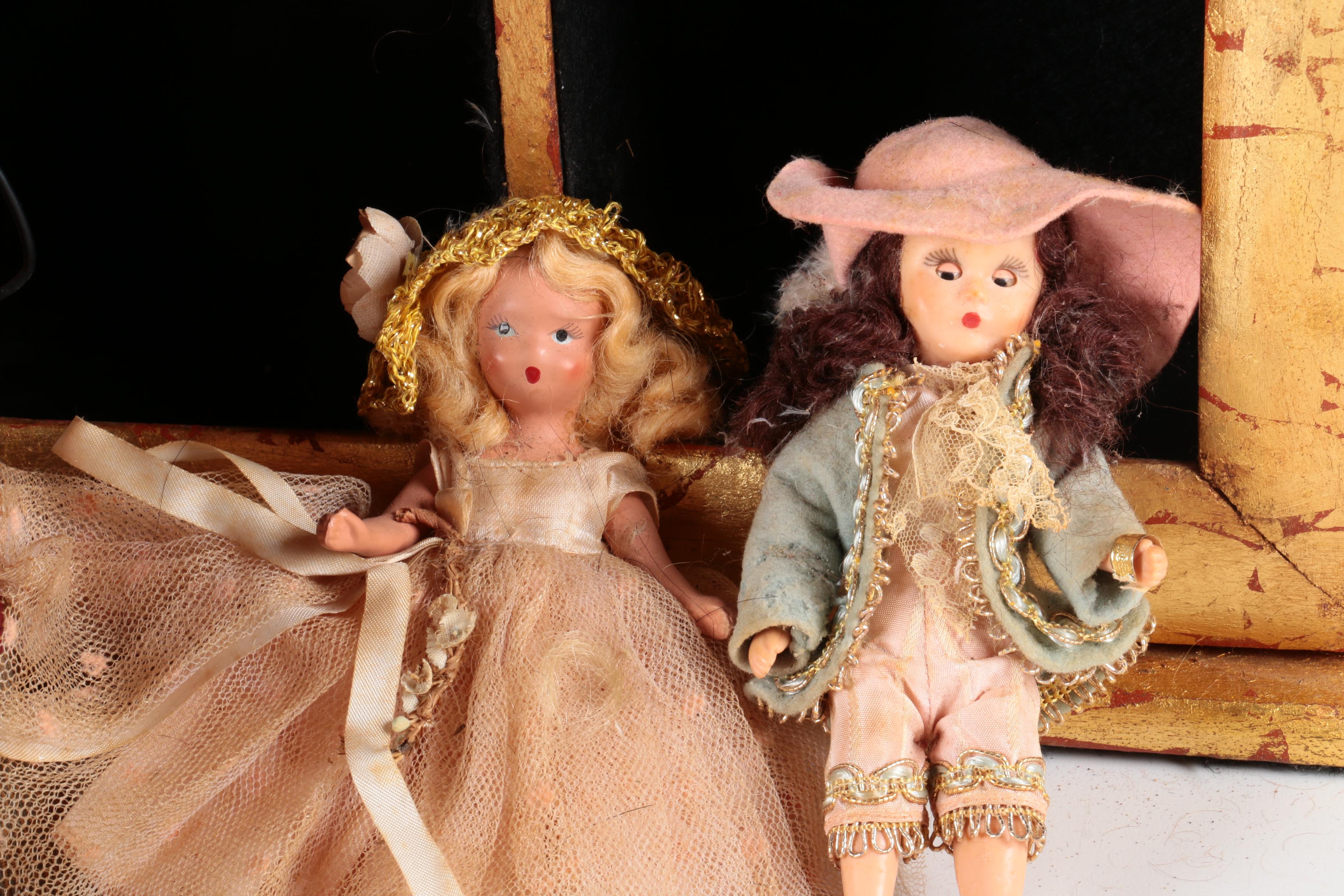 Variety of Dolls and Wooden Cabinet