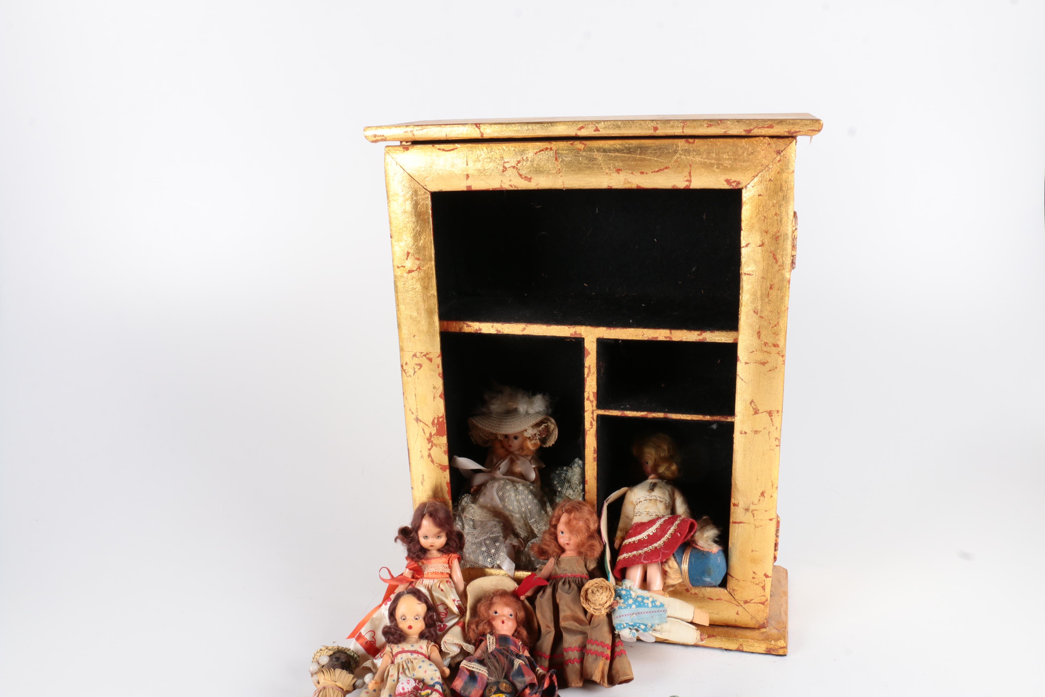 Variety of Dolls and Wooden Cabinet