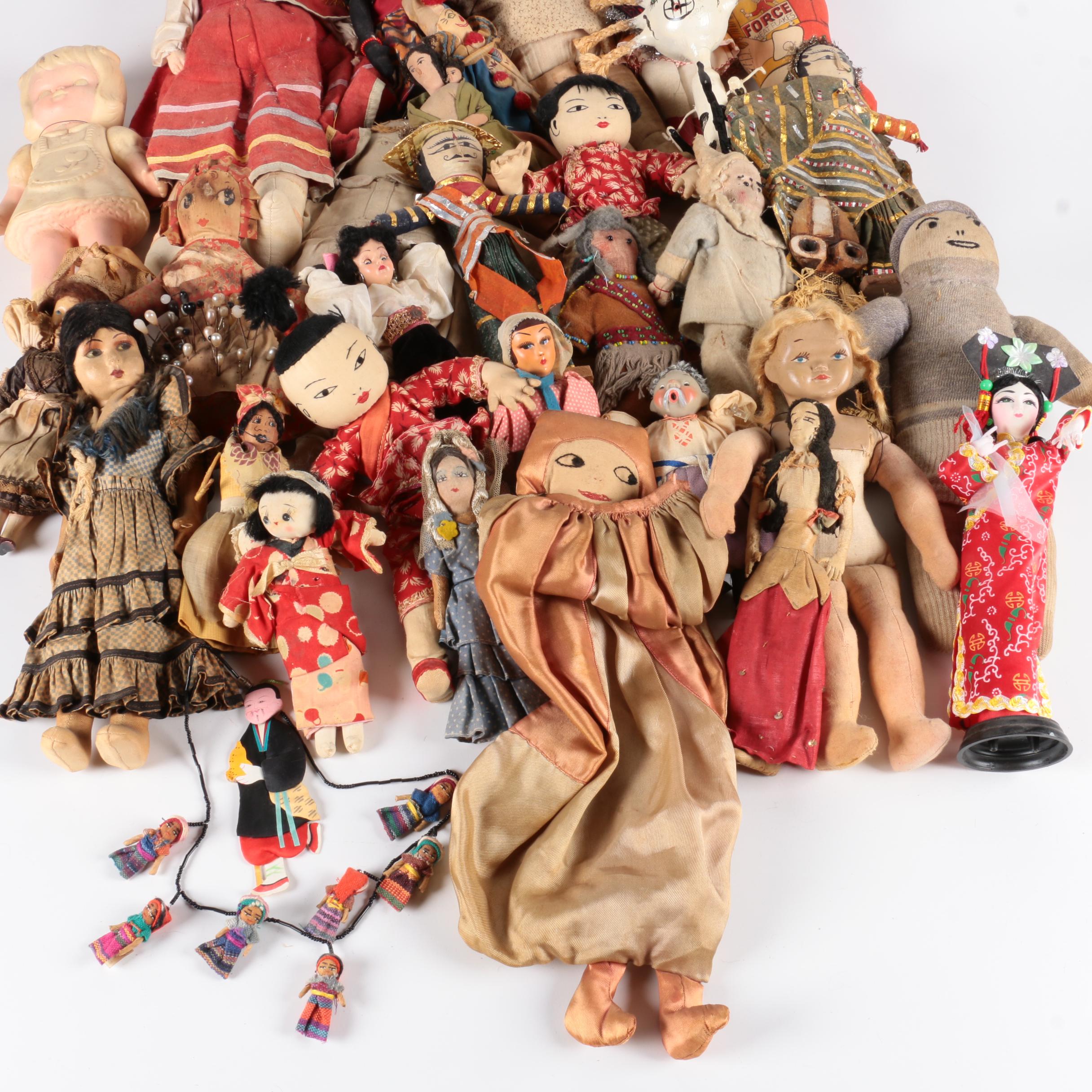 Variety of Dolls and Wooden Cabinet