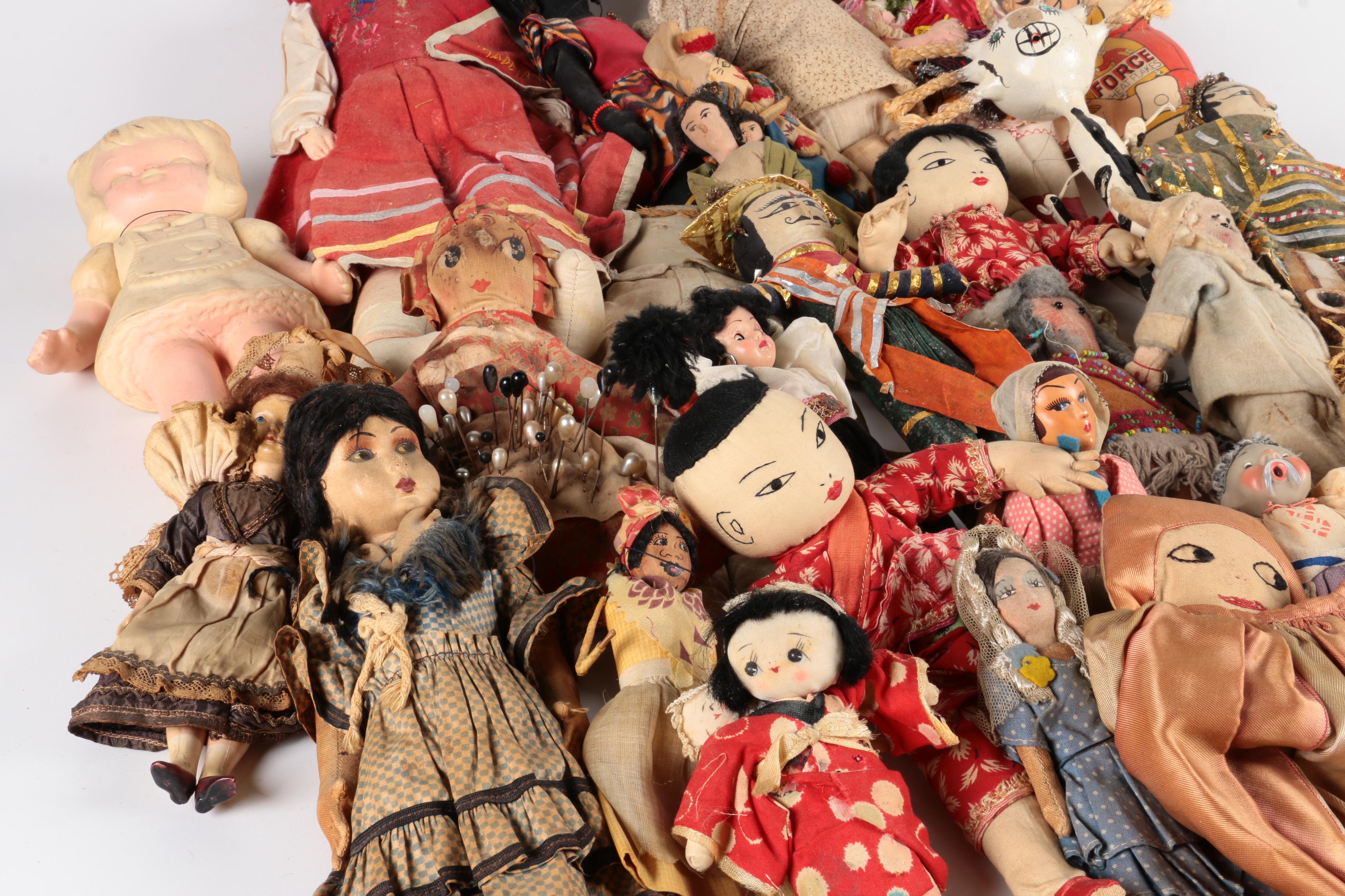 Variety of Dolls and Wooden Cabinet