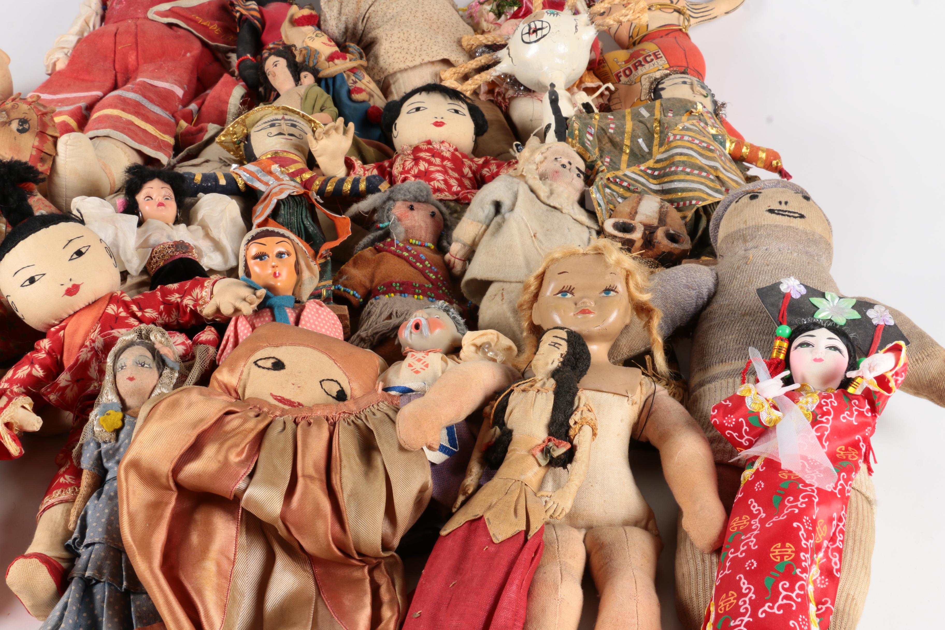 Variety of Dolls and Wooden Cabinet