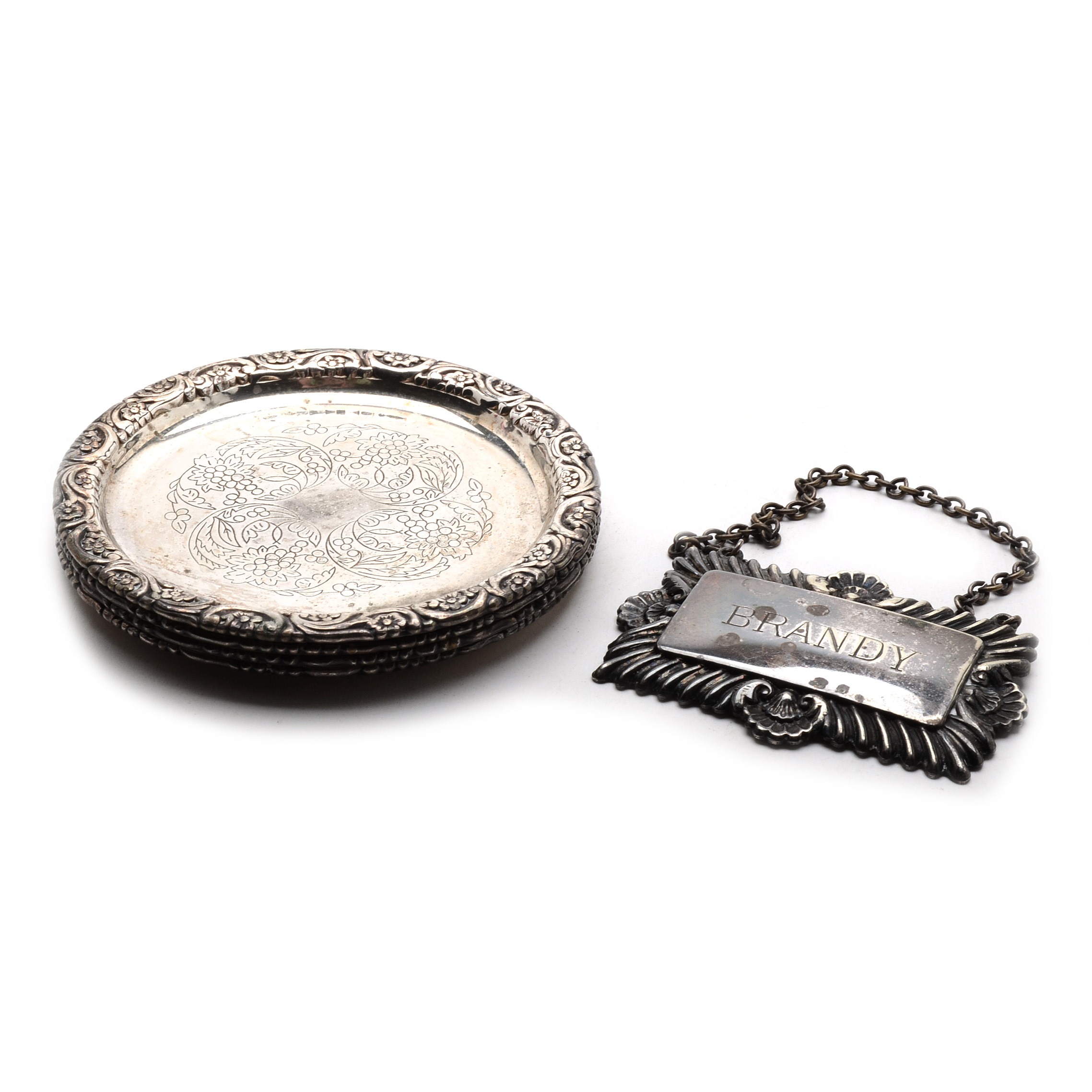 Set of Four Silverplated Coasters with a Brandy Decanter Tag