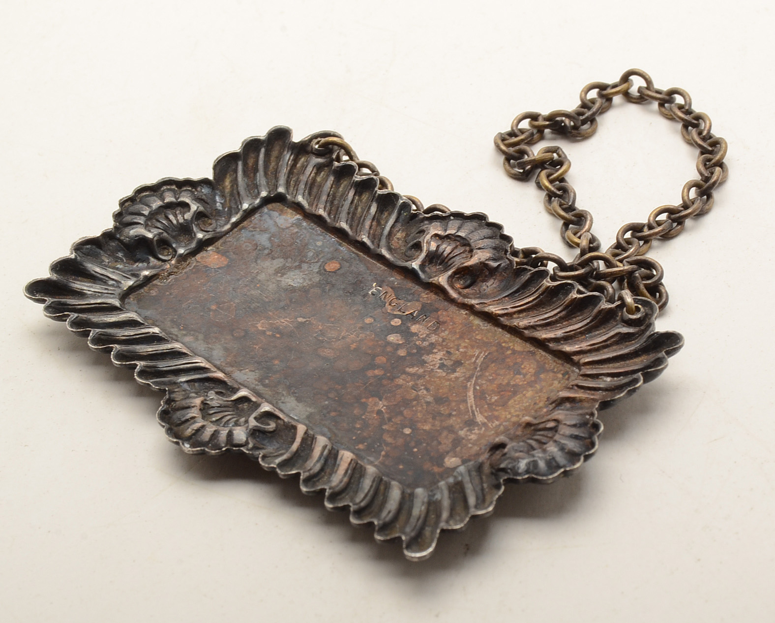 Set of Four Silverplated Coasters with a Brandy Decanter Tag