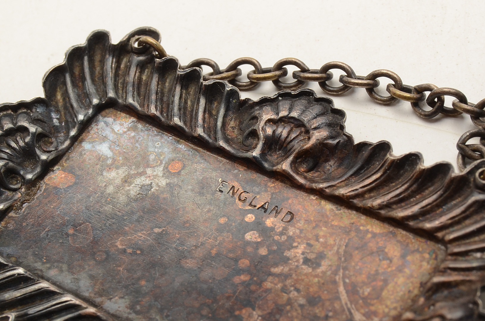 Set of Four Silverplated Coasters with a Brandy Decanter Tag