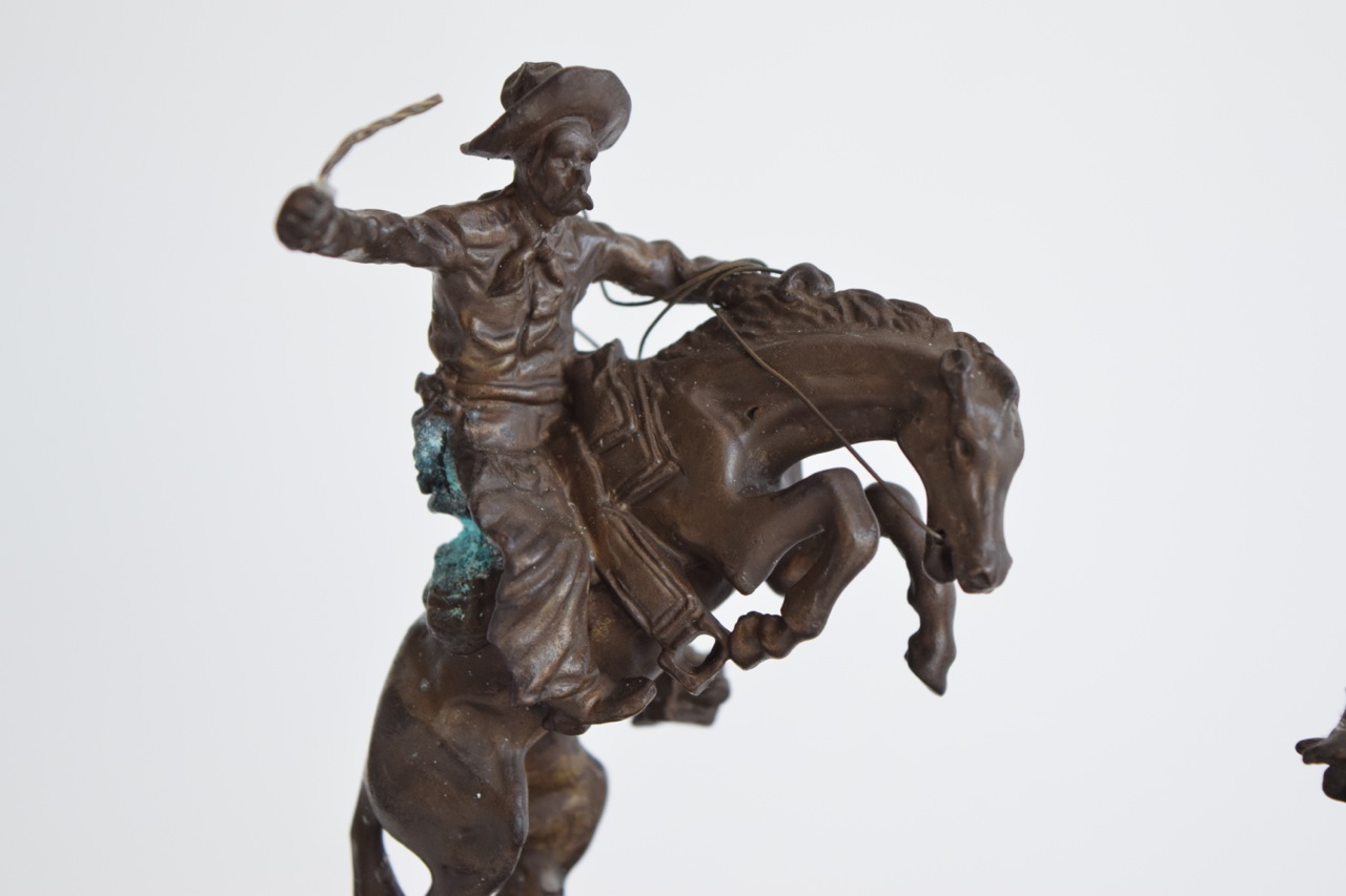 "The Rattlesnake" and "Bronco Buster" Reproduction Sculptures After Frederic Remington