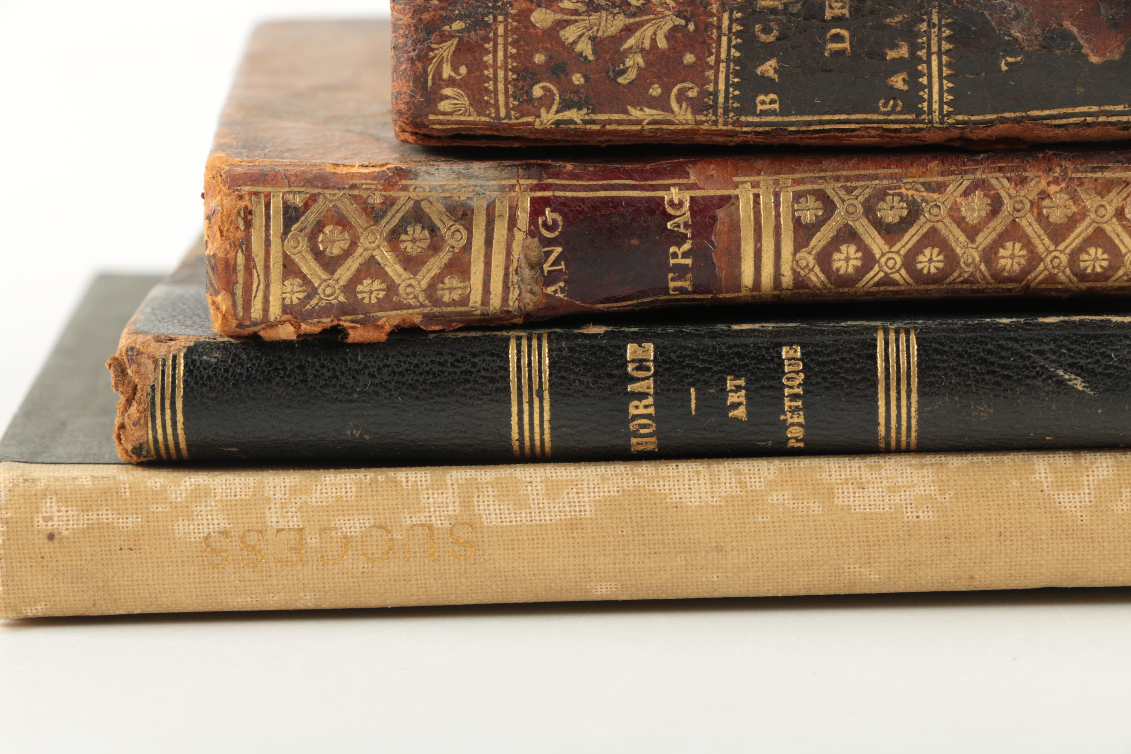Six Antique Books and Magnifying Glass