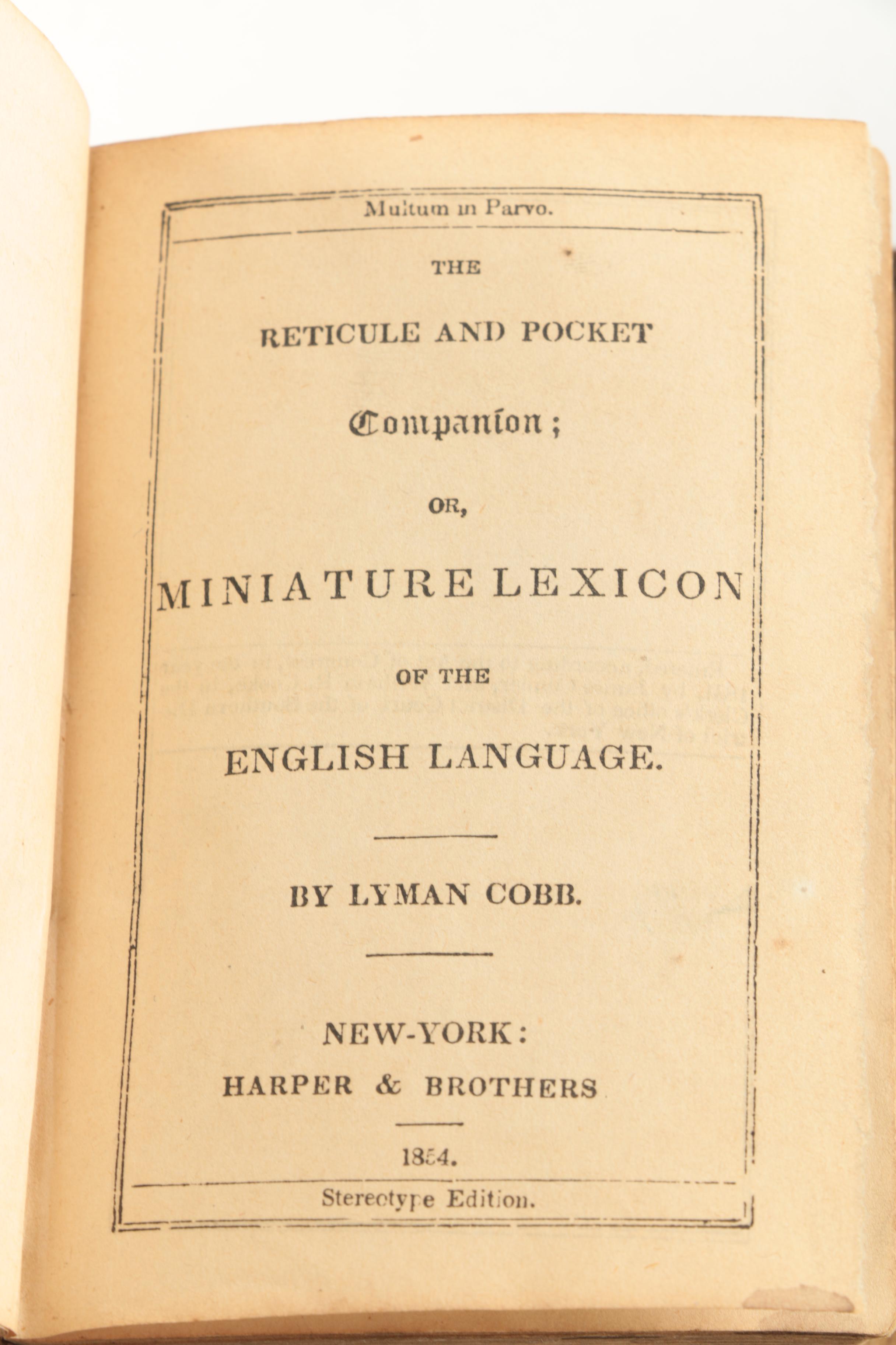 Six Antique Books and Magnifying Glass