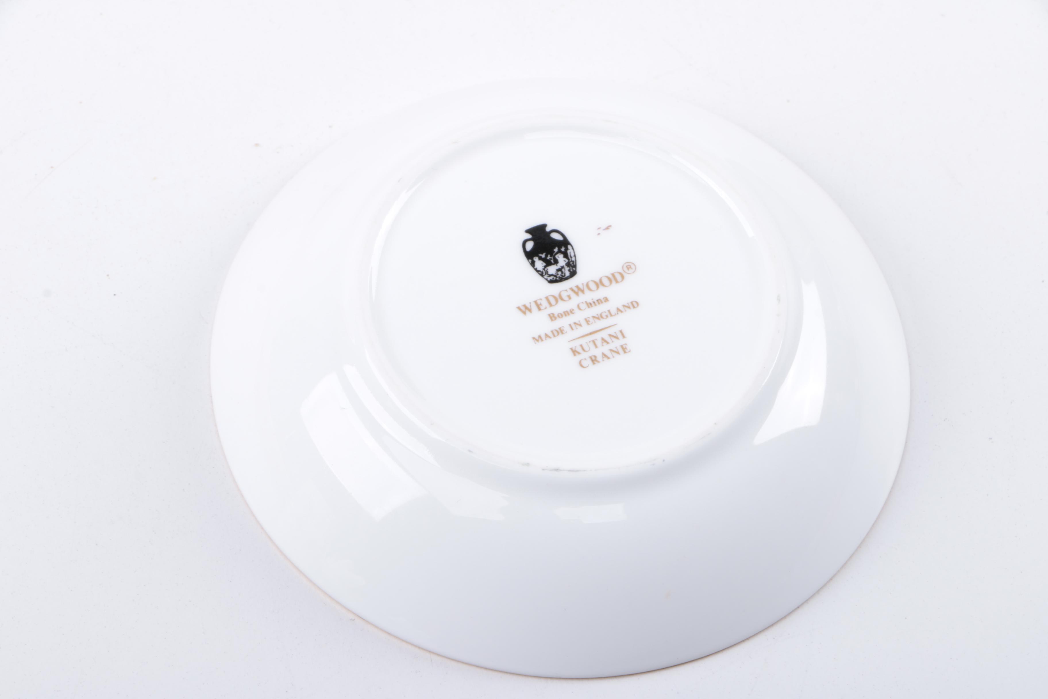 Gold Trimmed Porcelain Plates Featuring Wedgwood