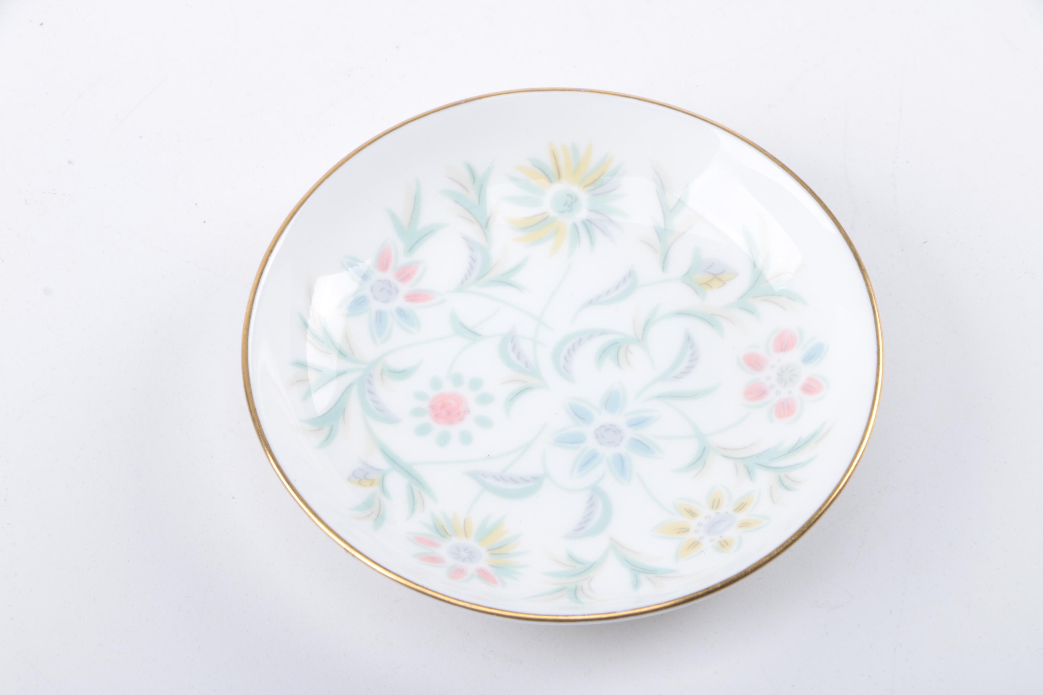 Gold Trimmed Porcelain Plates Featuring Wedgwood