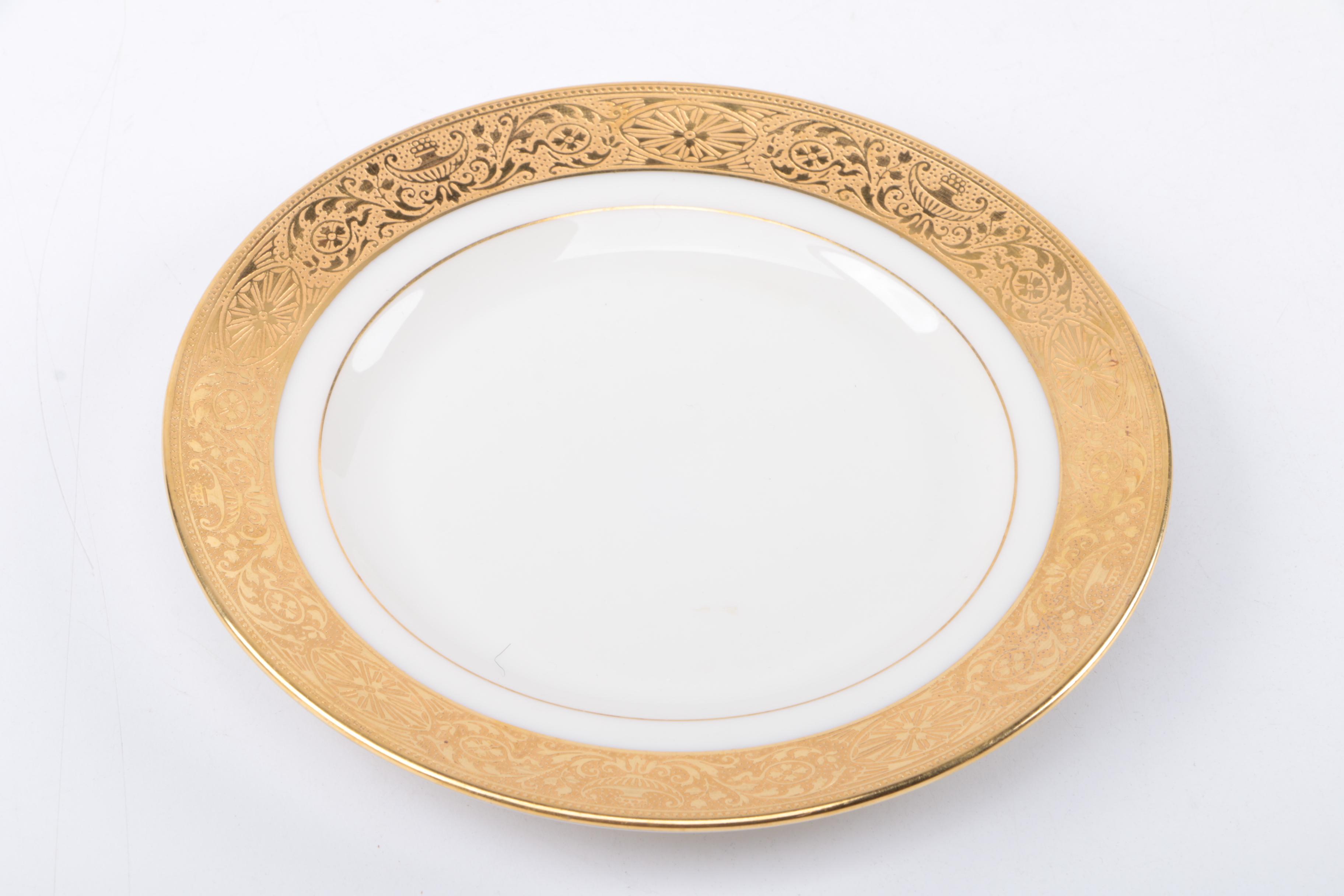 Gold Trimmed Porcelain Plates Featuring Wedgwood