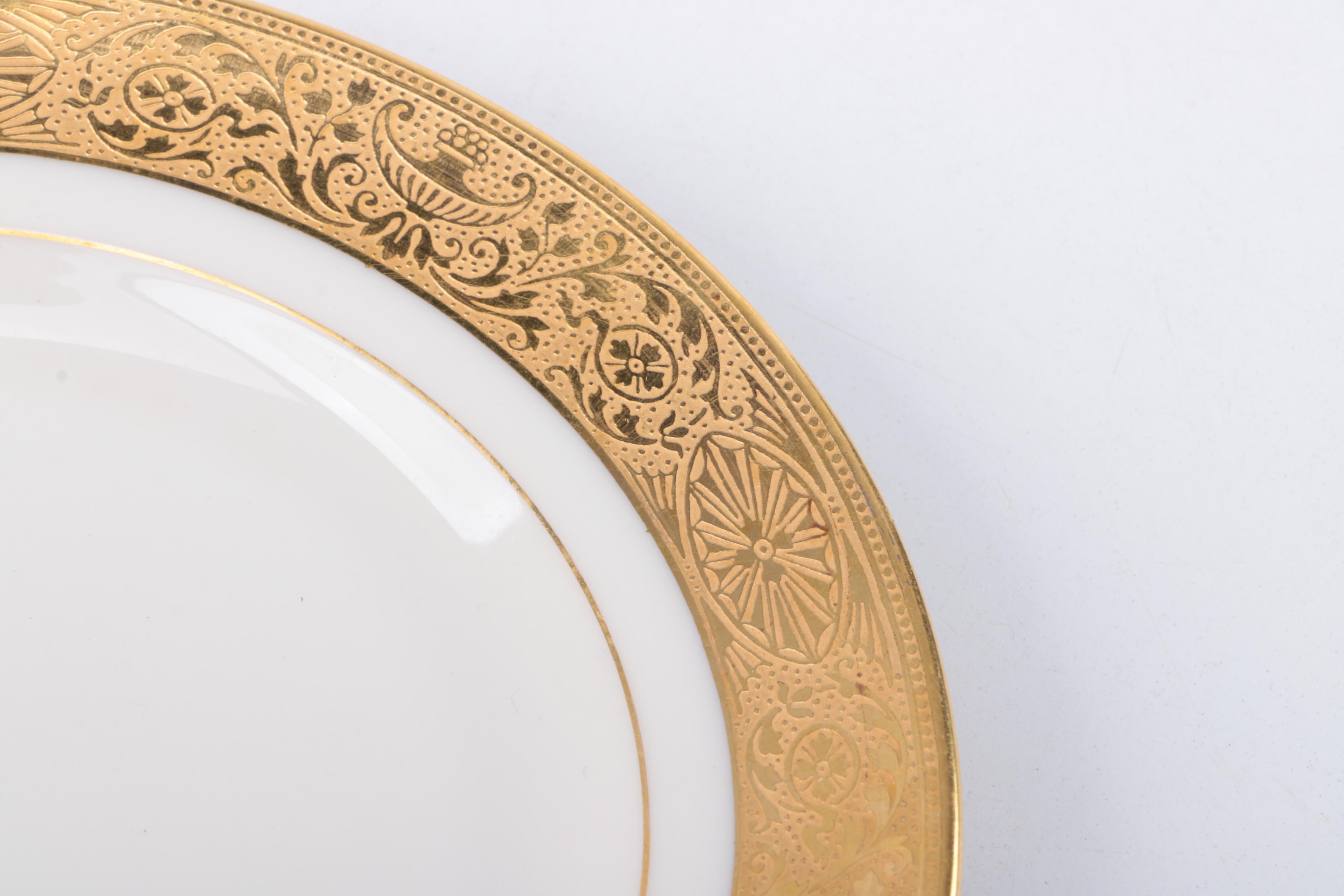 Gold Trimmed Porcelain Plates Featuring Wedgwood