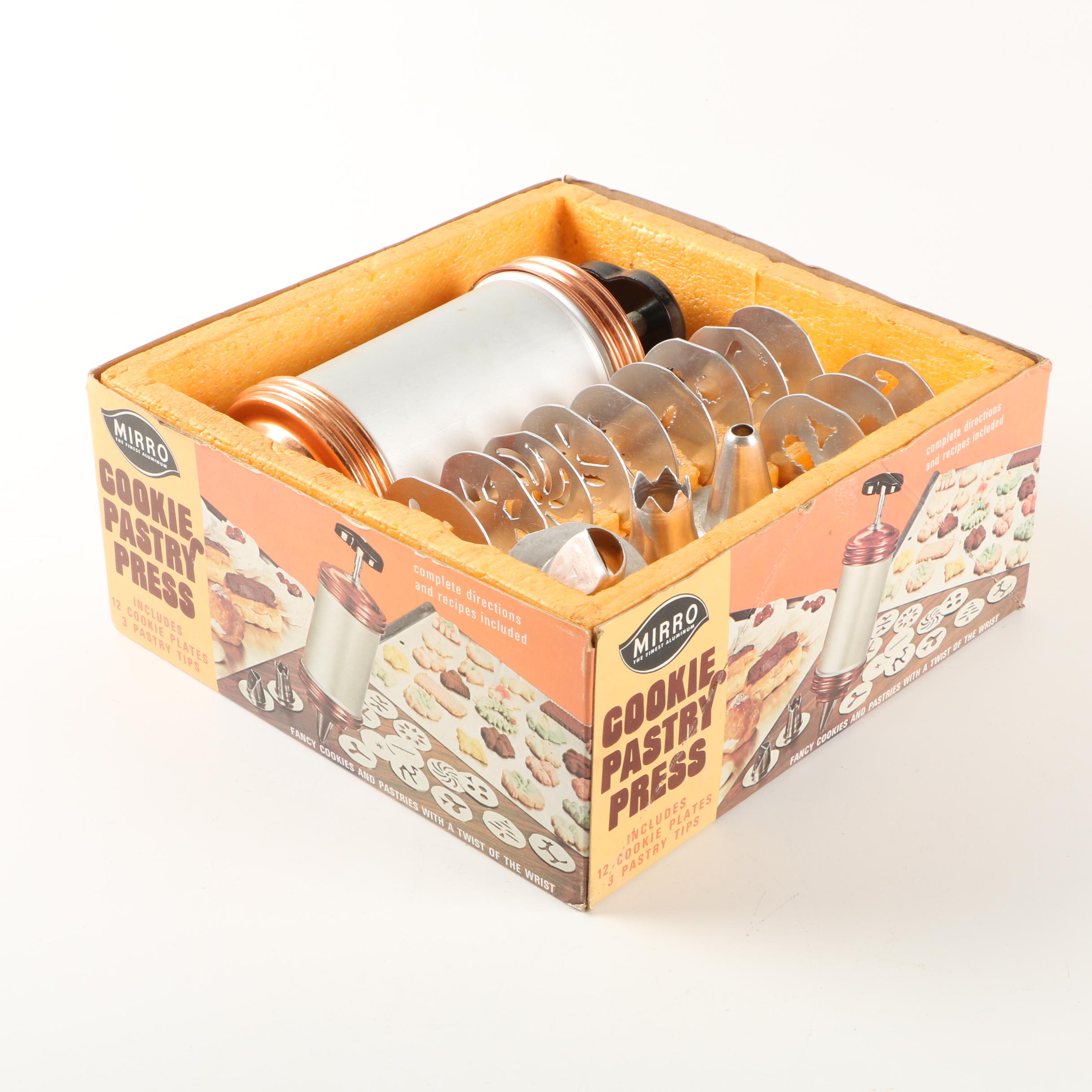 Assortment of kitchenwares featuring a Mirro cookie pastry press