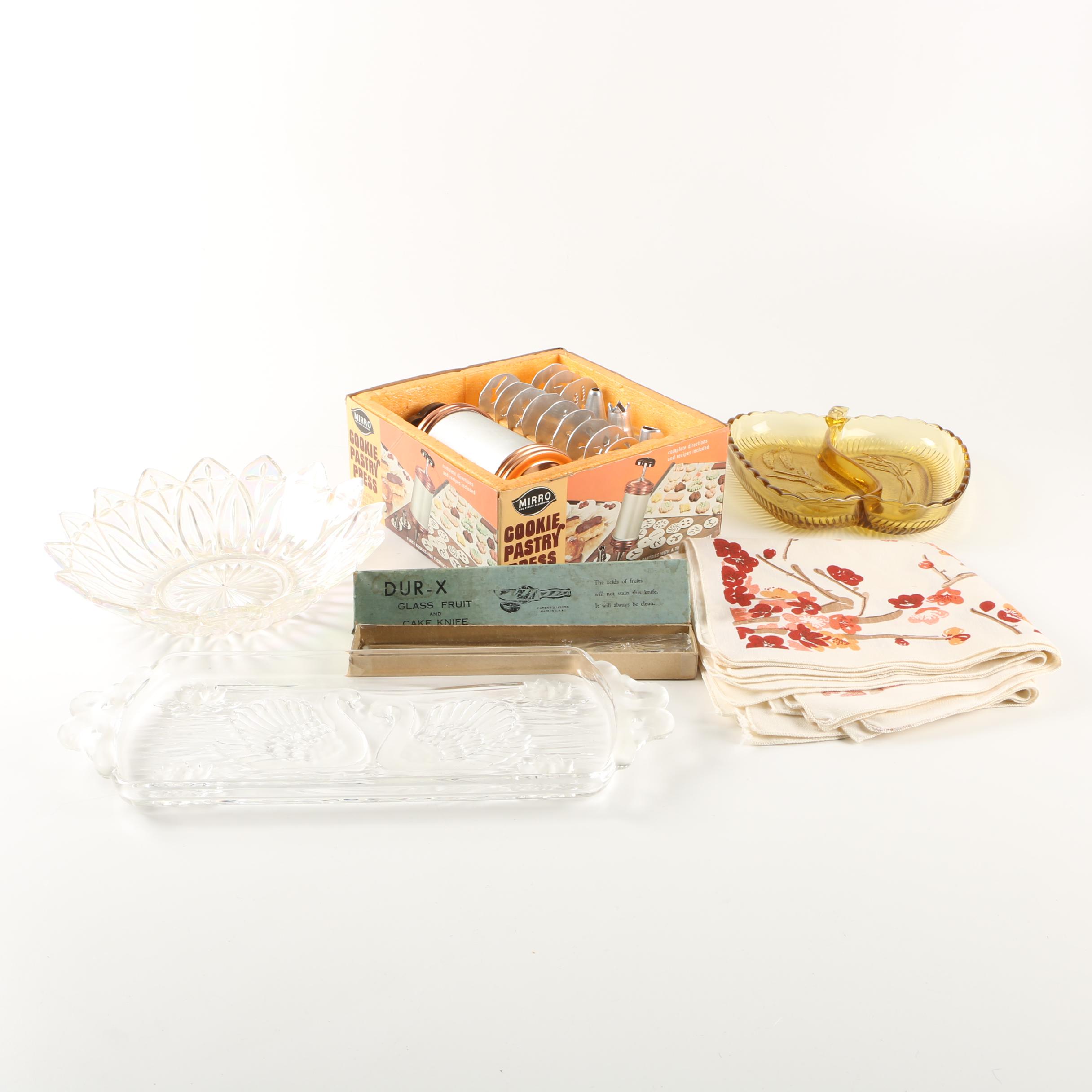 Assortment of kitchenwares featuring a Mirro cookie pastry press